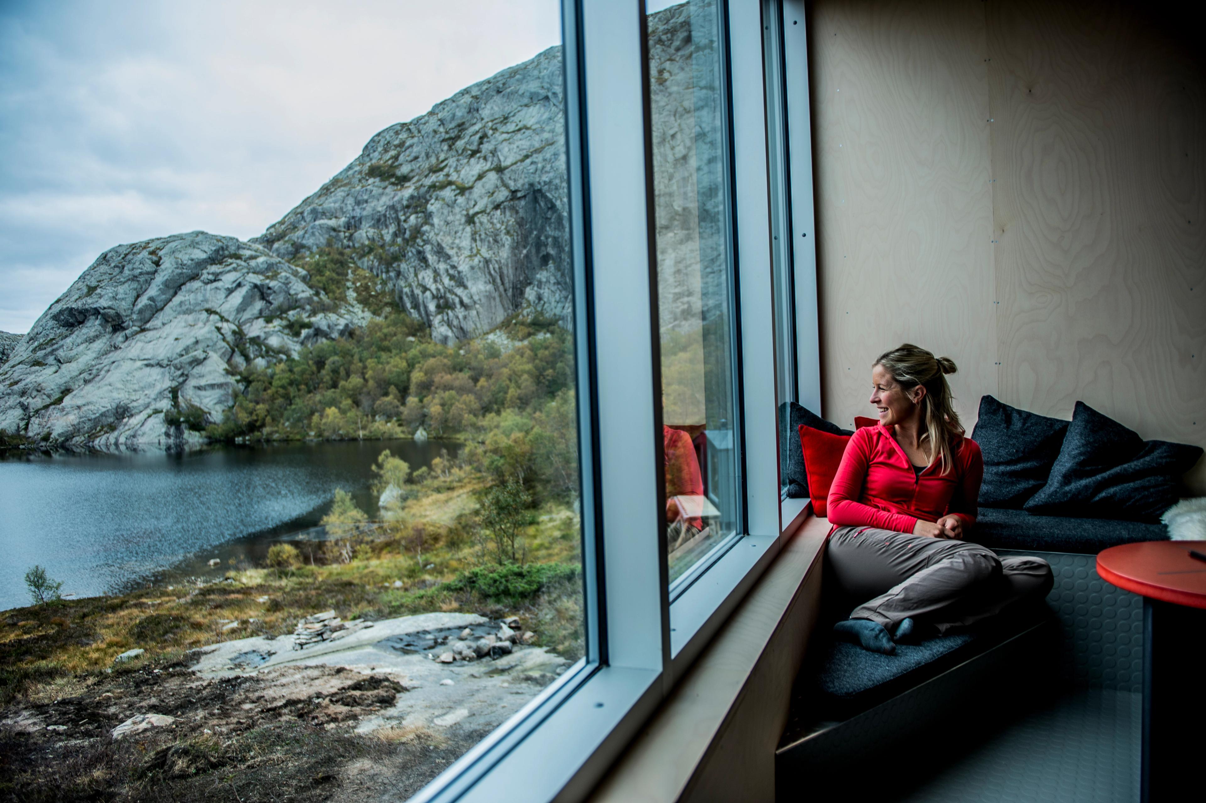 A woman enjoying the view from a cabin.