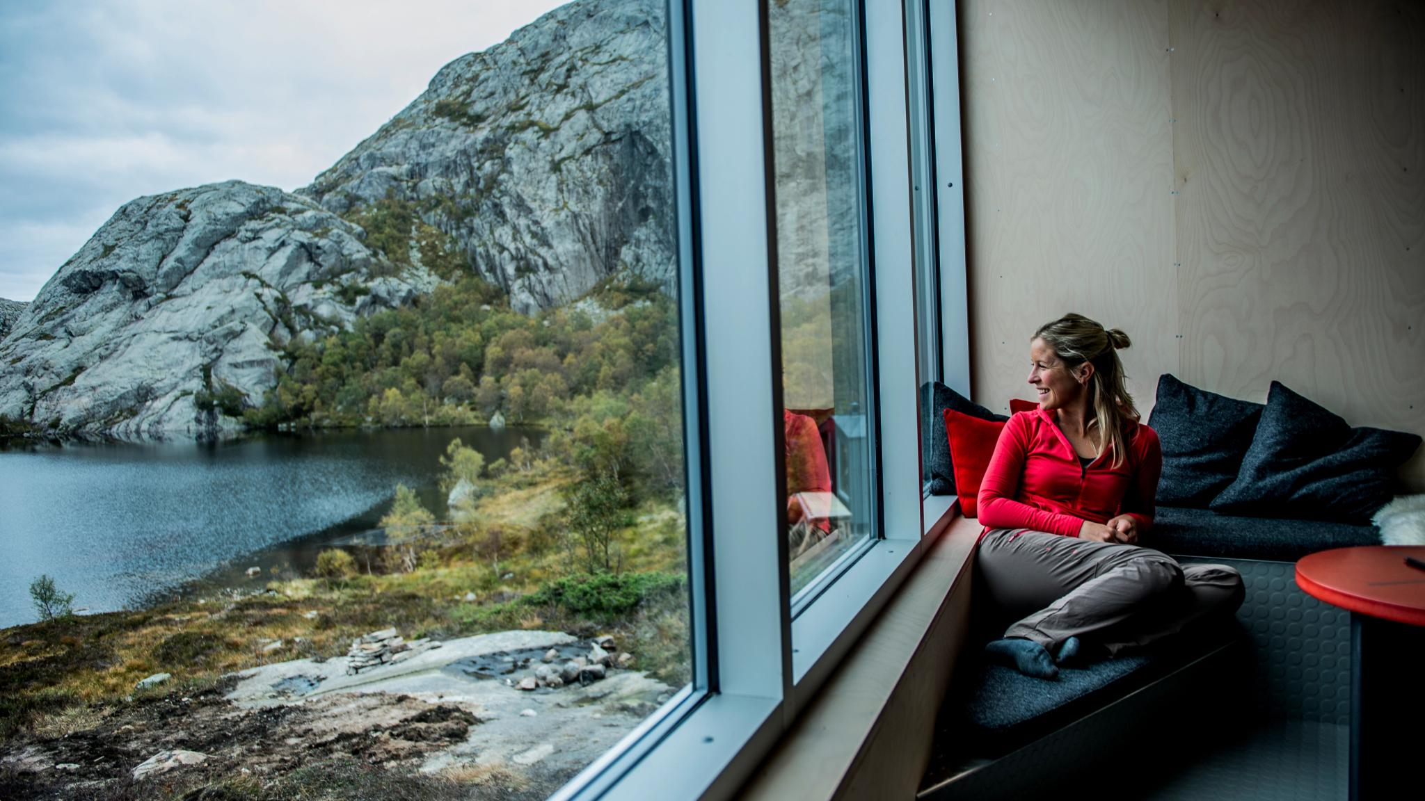 A woman enjoying the view from a cabin.