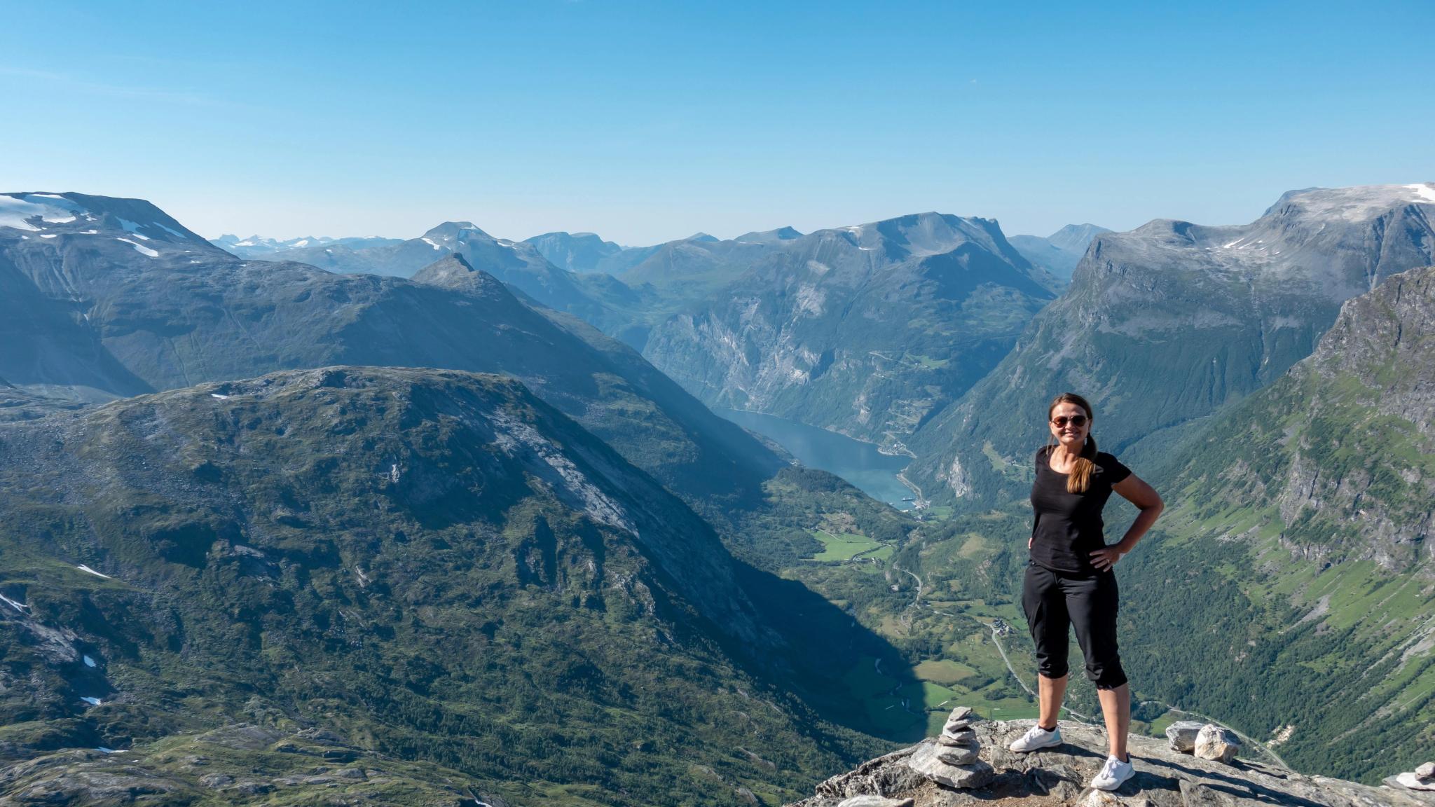 Woman standing on top of a mountain in Norway