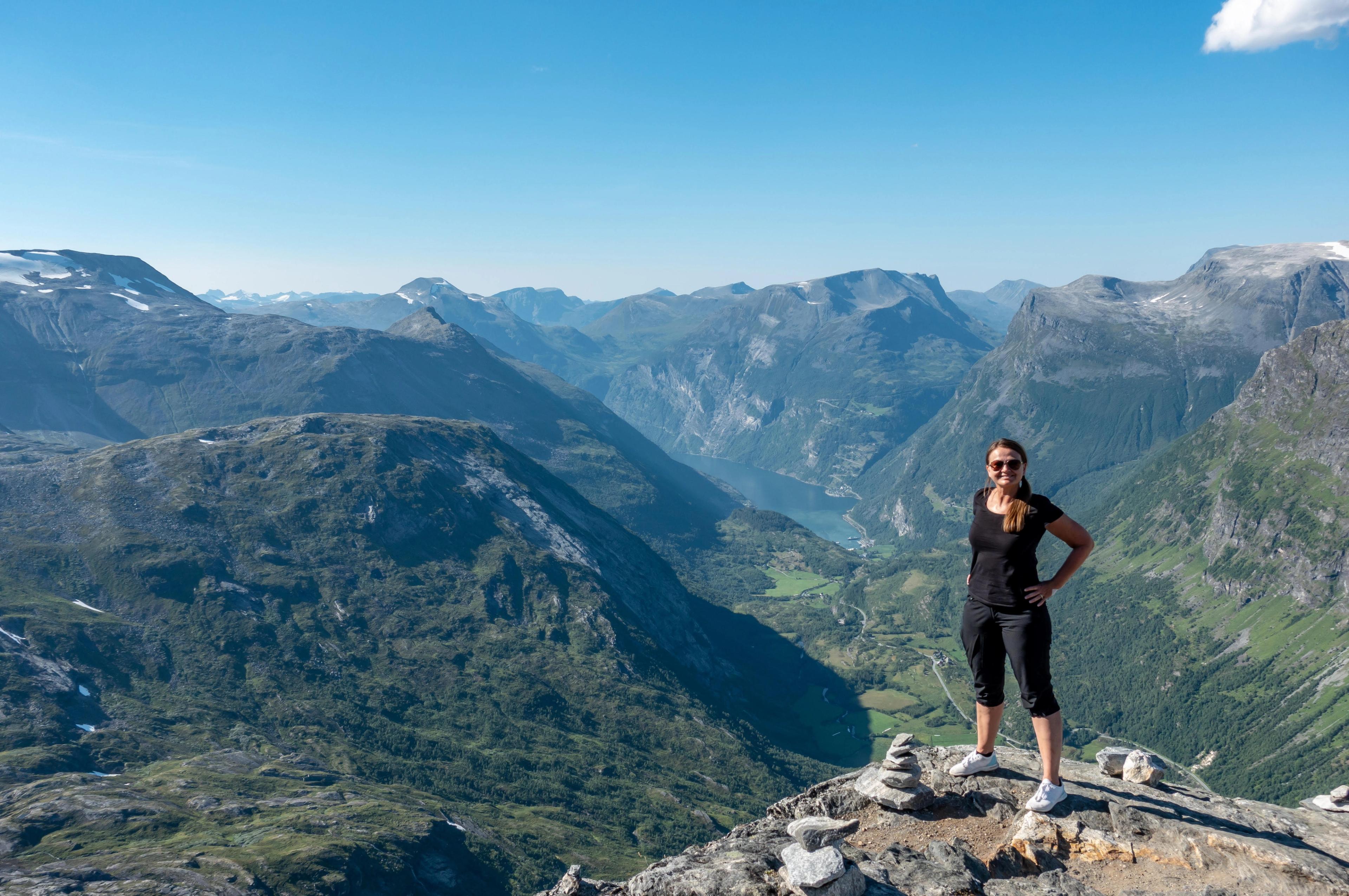 Woman standing on top of a mountain in Norway