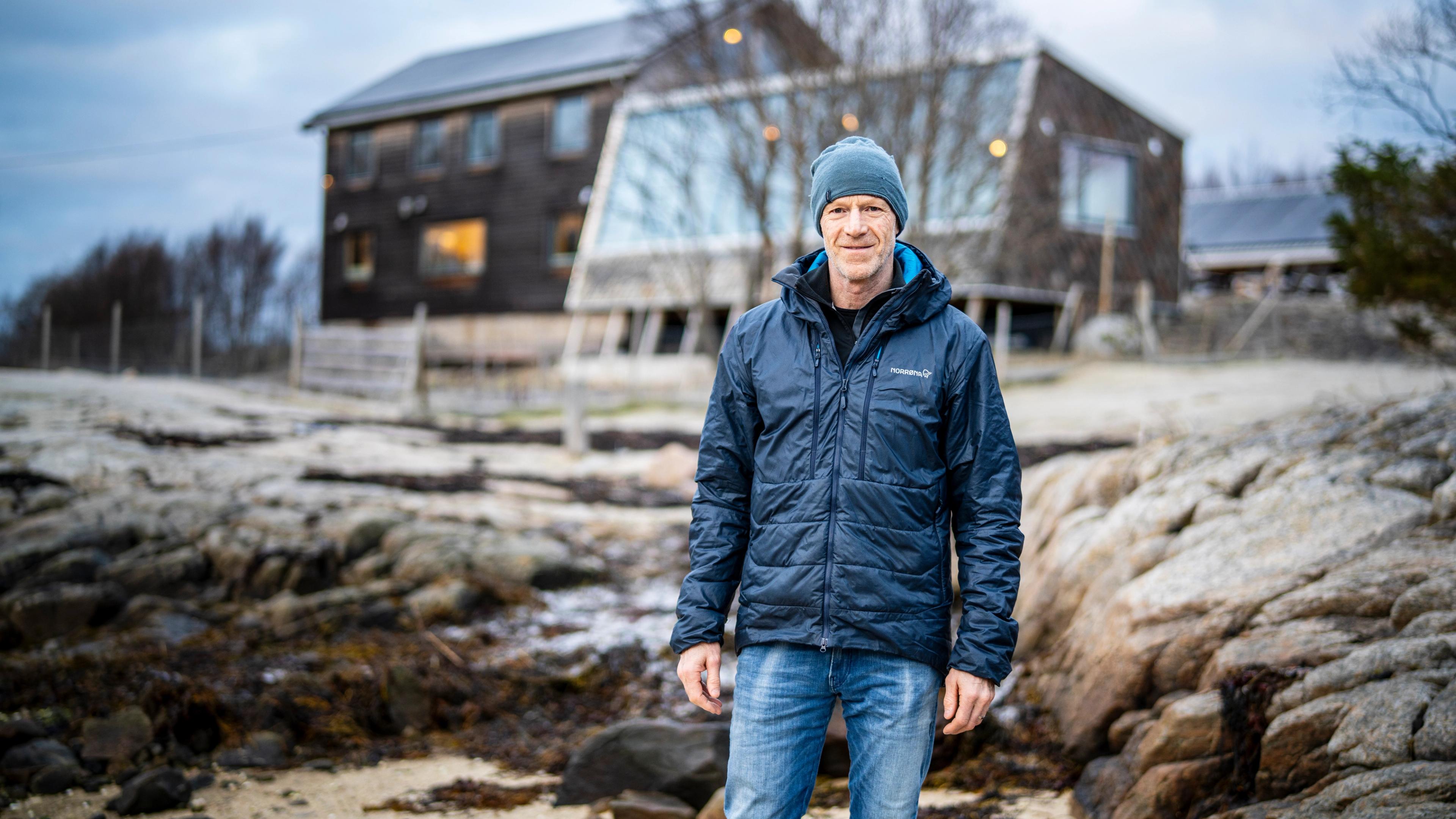 A man in front of a house in the Arctic