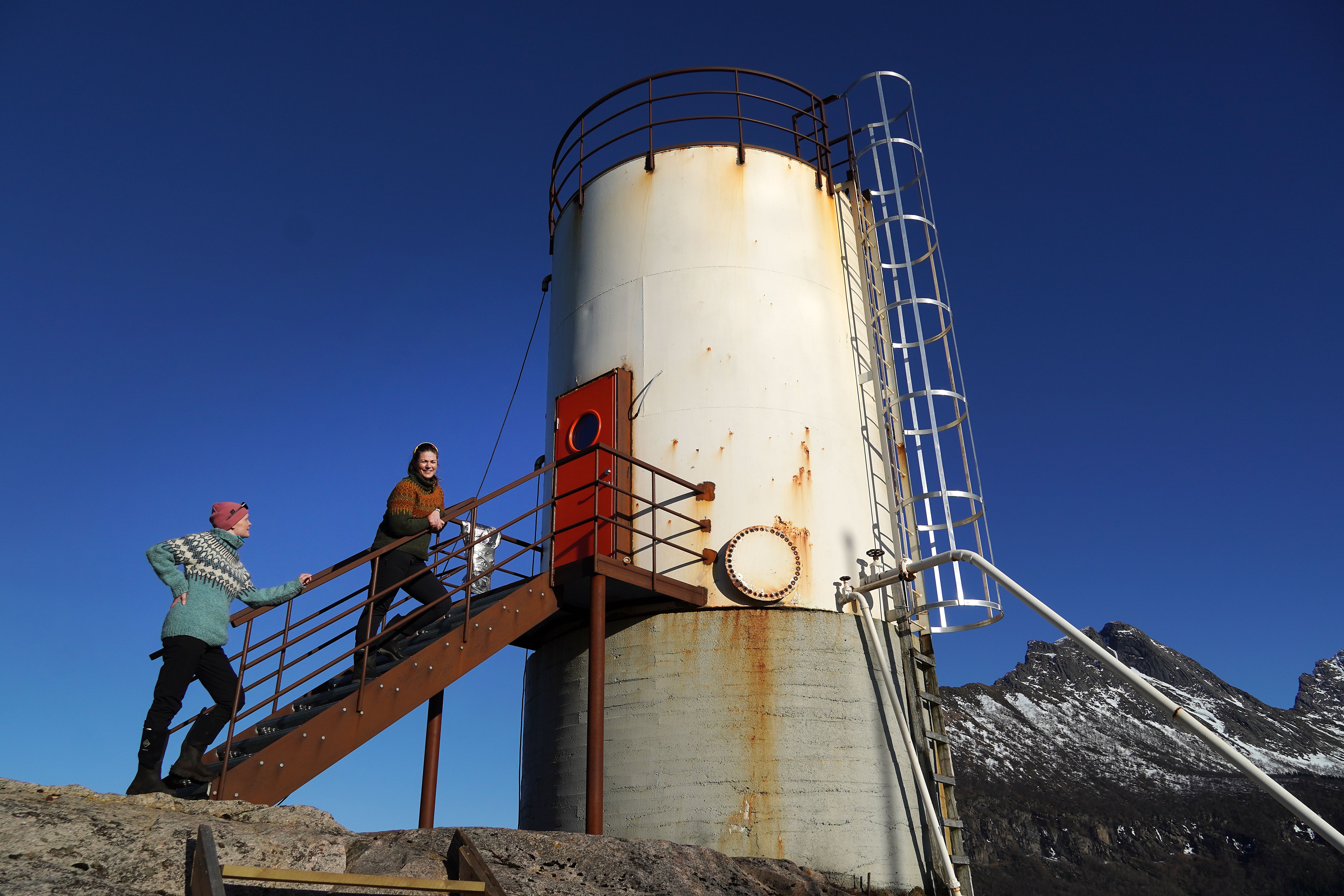 Two woman and an oil tank contervted to a hotel