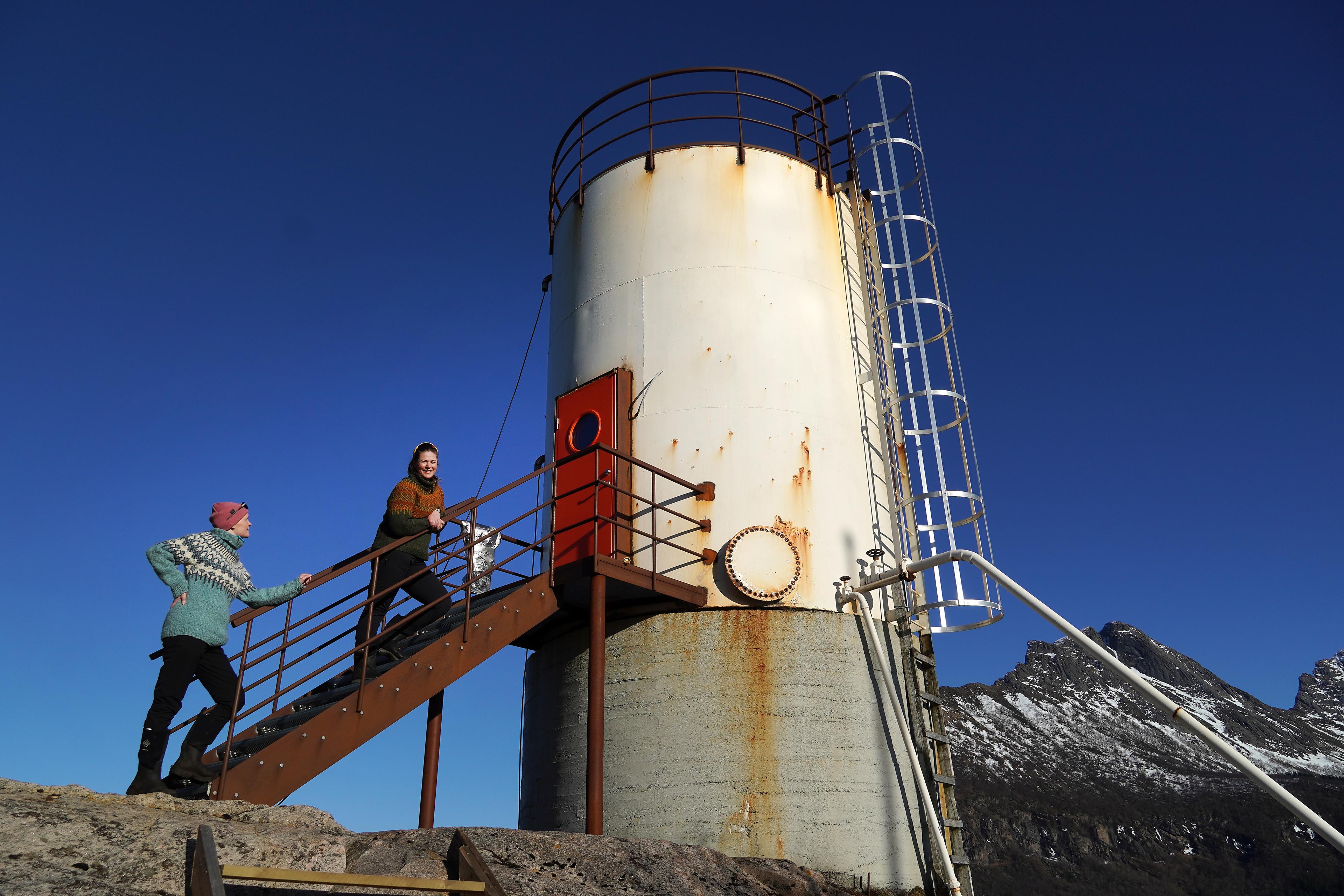 Two woman and an oil tank contervted to a hotel