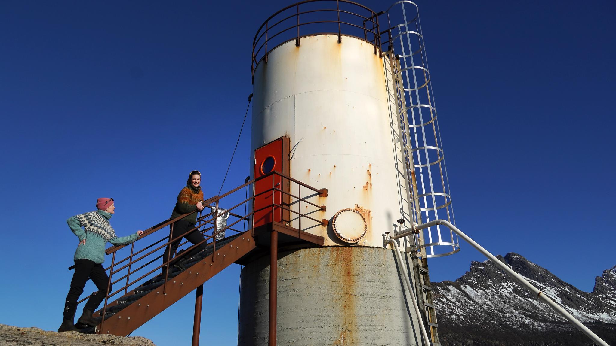 Two woman and an oil tank contervted to a hotel