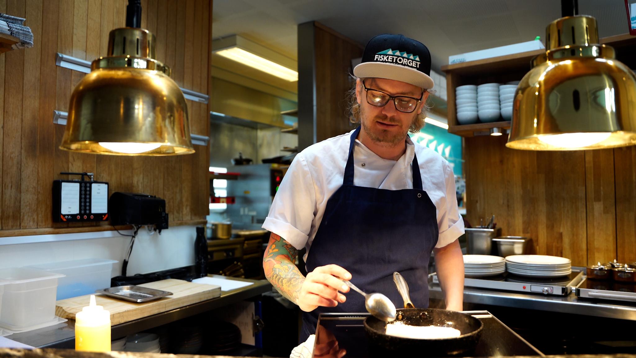 Karl Erik frying fish at Fisketorget restaurant in Stavanger, Fjord Norway.