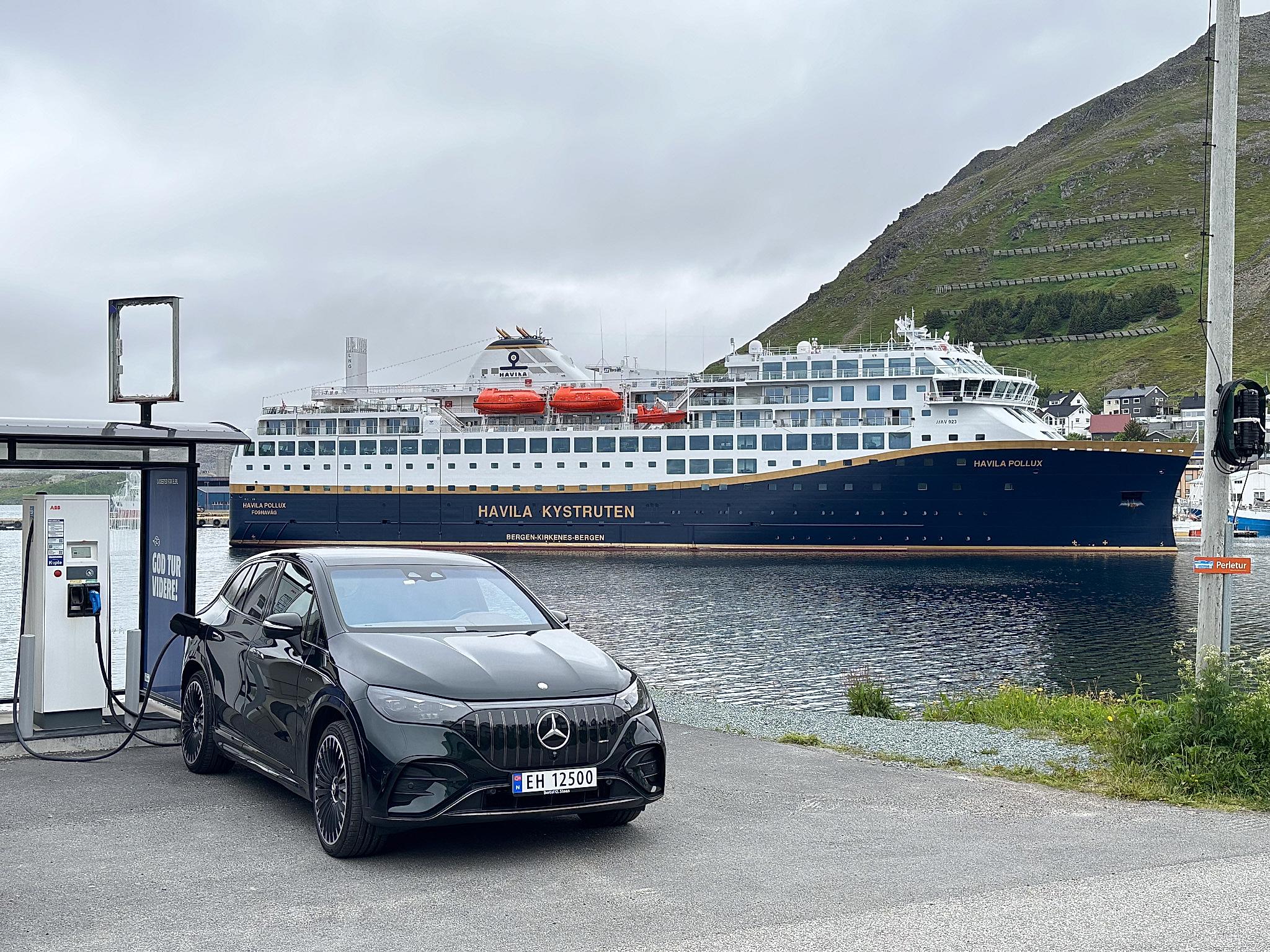 An electric car charging in front of a Havila ship