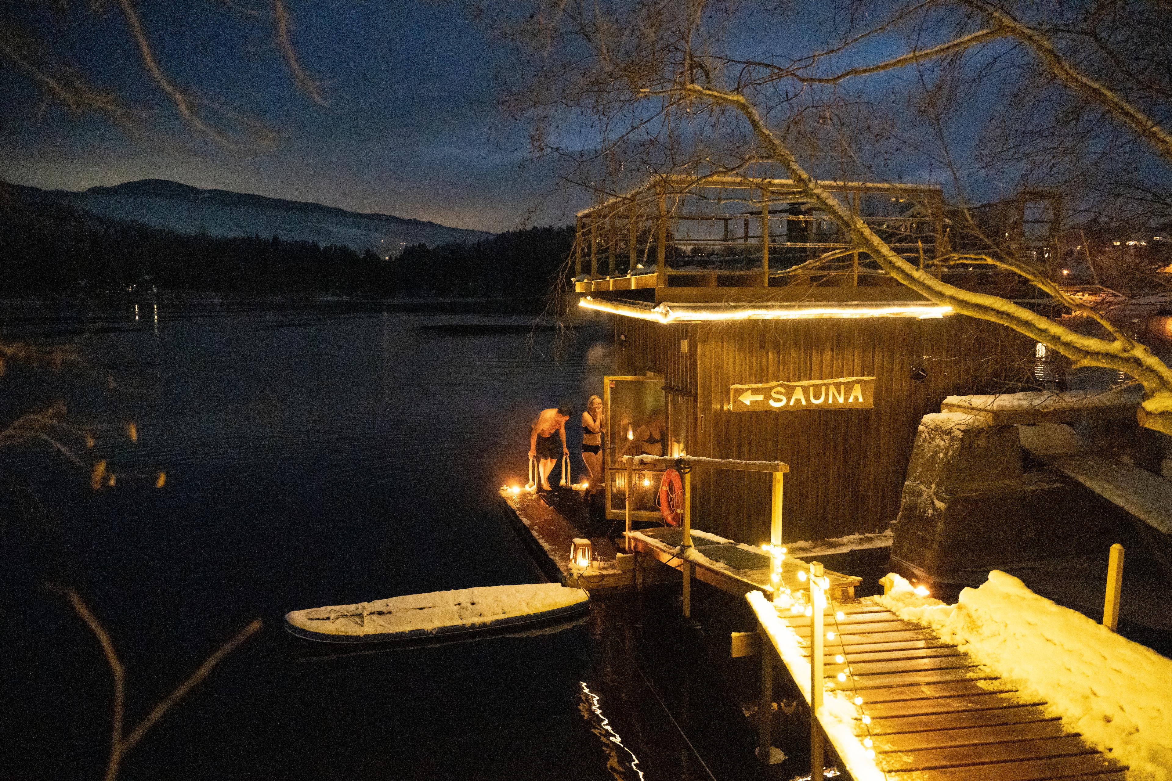 People entering a sauna after swimming.