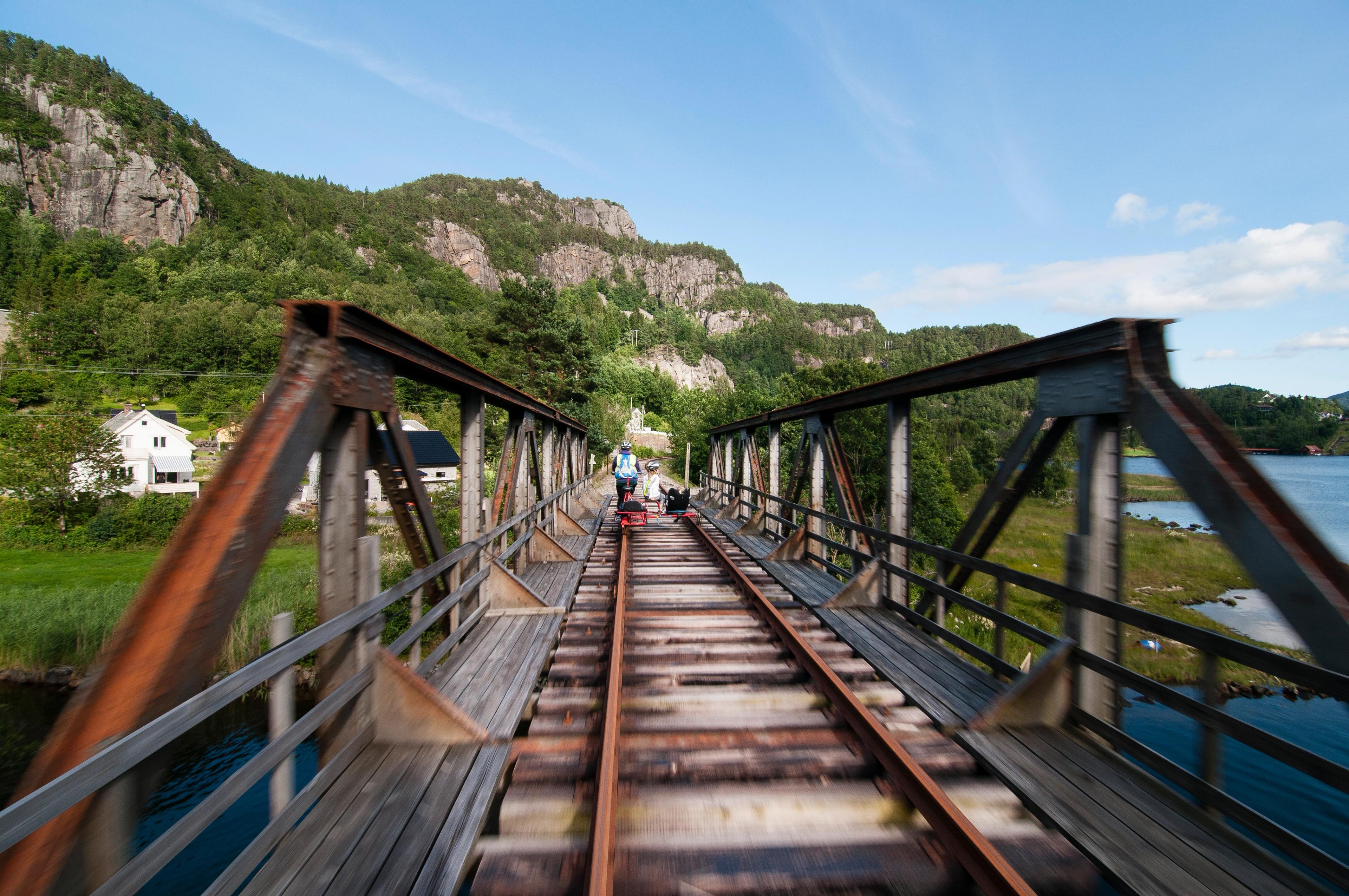 People riding a rail bike in Flekkefjord, Norway