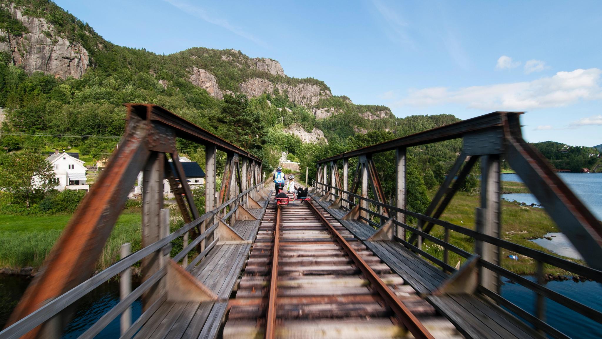 People riding a rail bike in Flekkefjord, Norway