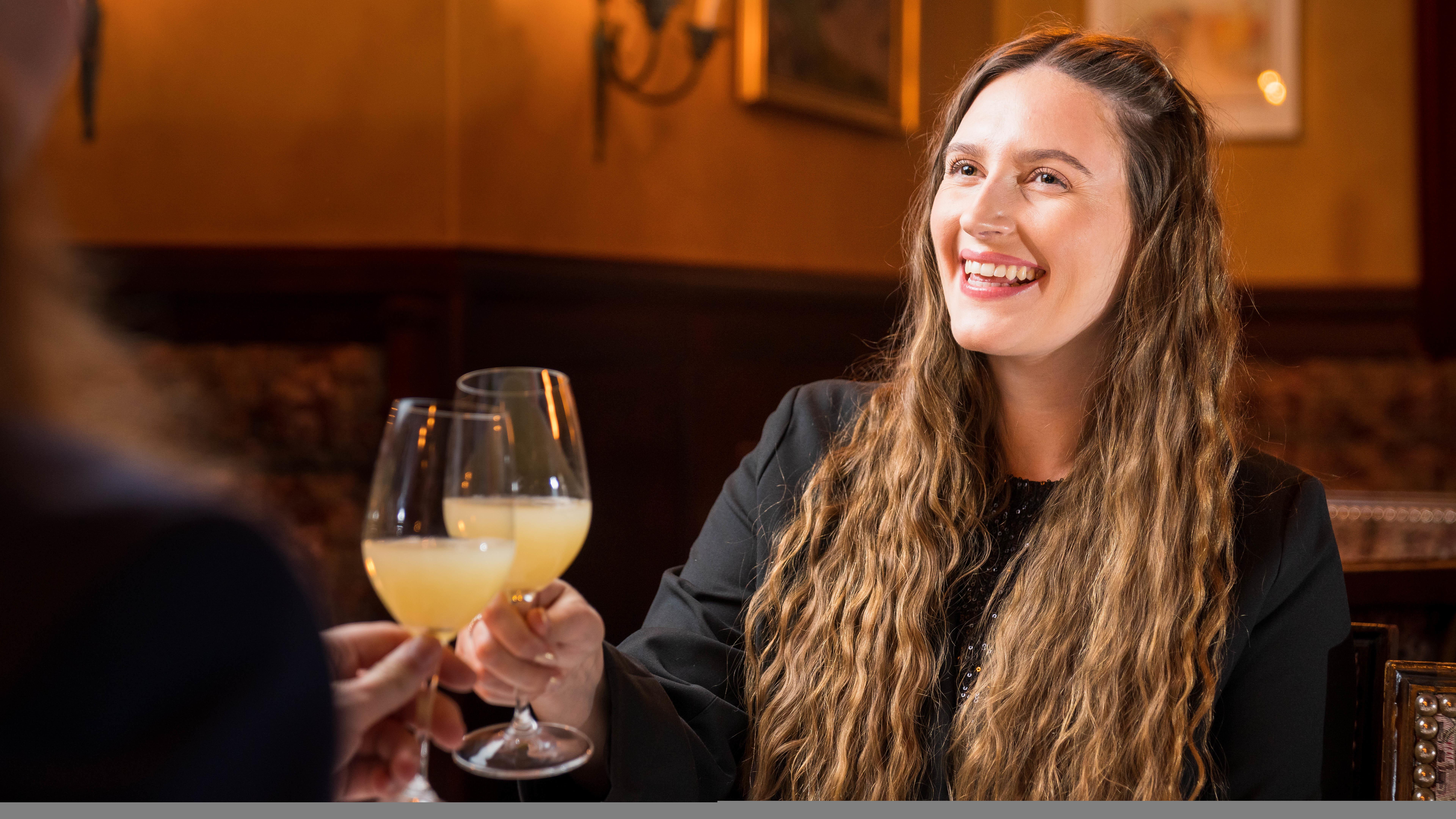 To people doing a toast at a Christmas dinner at Gamle Raadhus Restaurant in Oslo