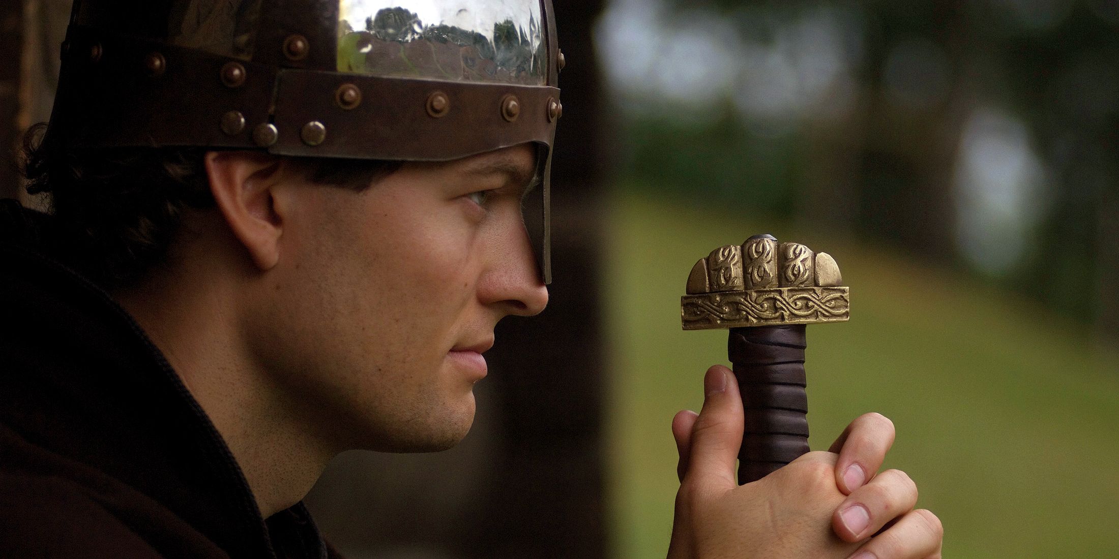 Close up picture of a man in Viking outfit carrying a sword in Trøndelag