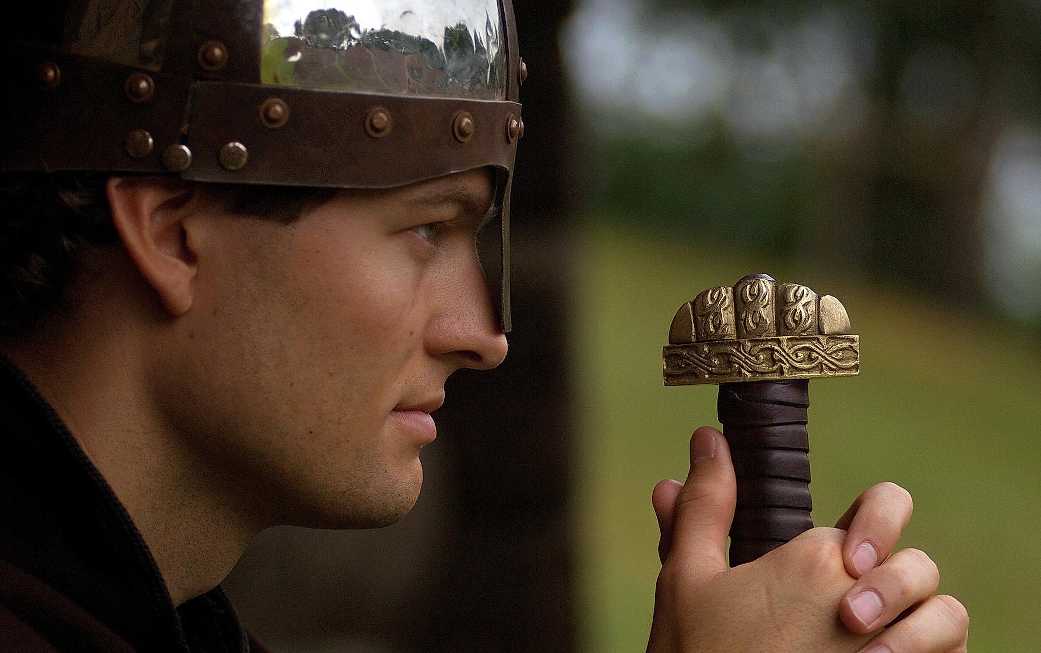 Close up picture of a man in Viking outfit carrying a sword in Trøndelag