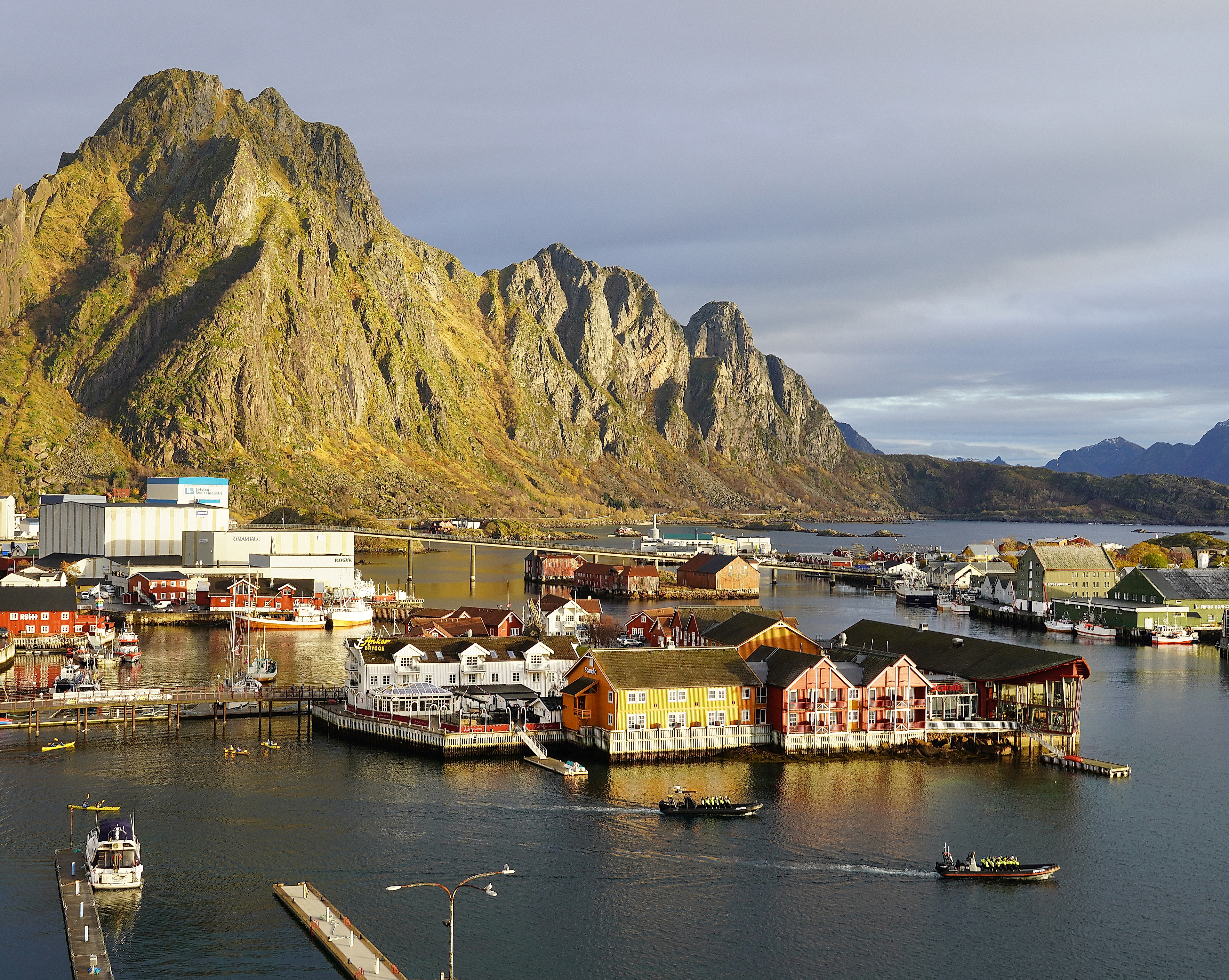 The tourist town and fishing village of Svolvær in Lofoten below tall mountains.