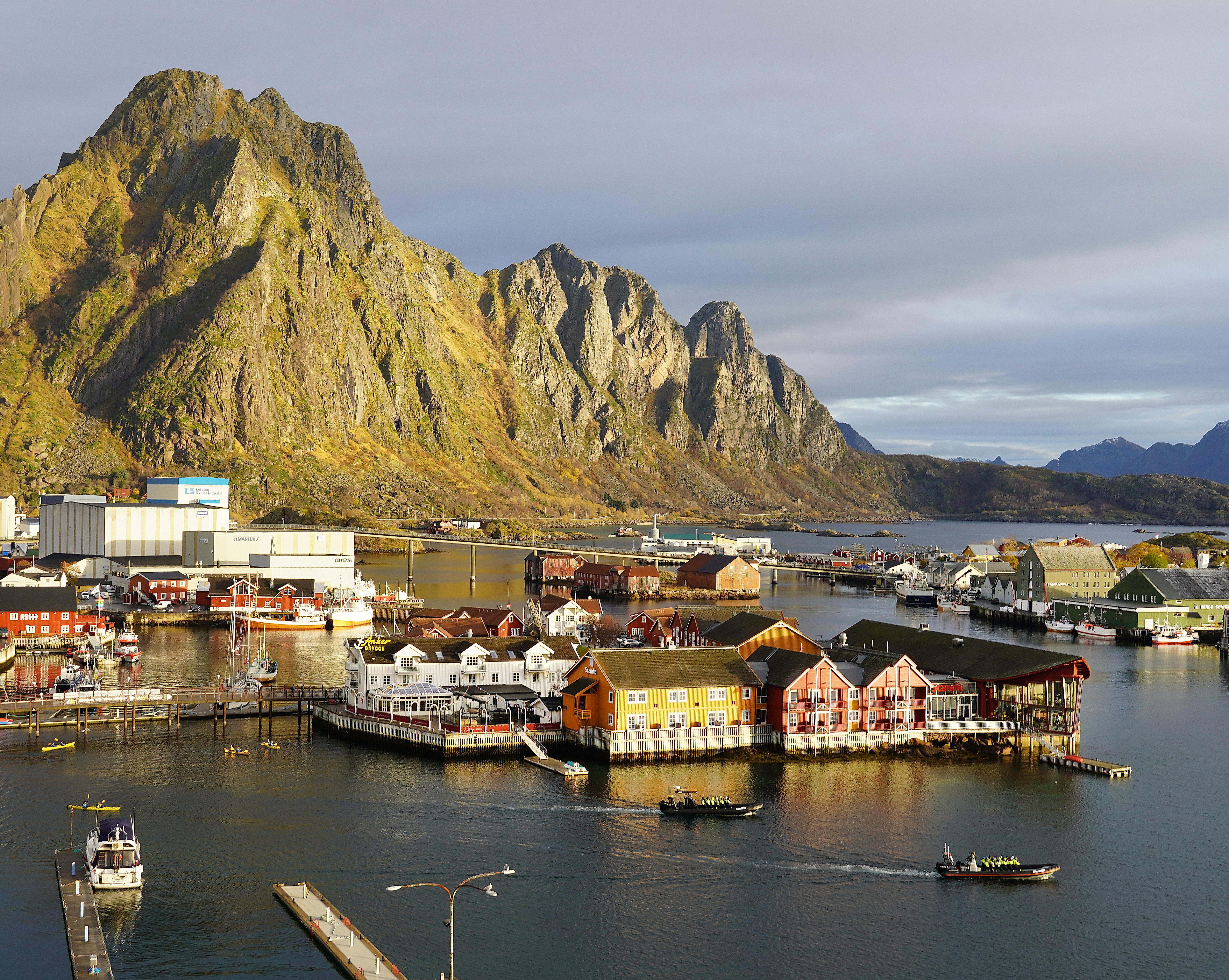 The tourist town and fishing village of Svolvær in Lofoten below tall mountains.