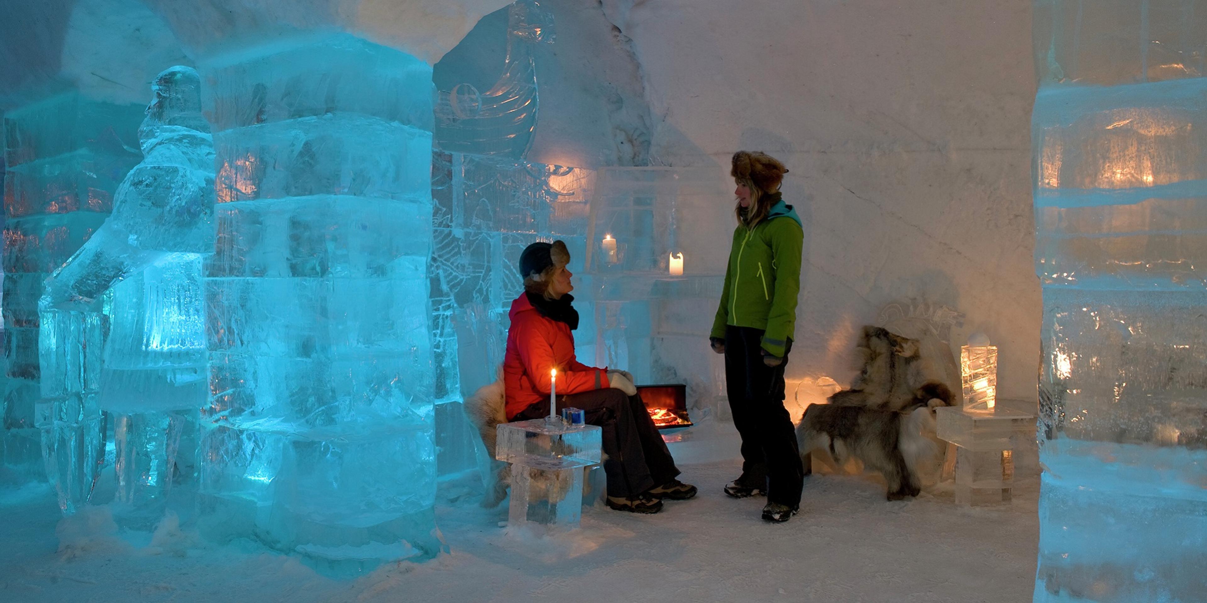 A couple inside the Sorrisniva Igloo Hotel in Alta, Northern Norway
