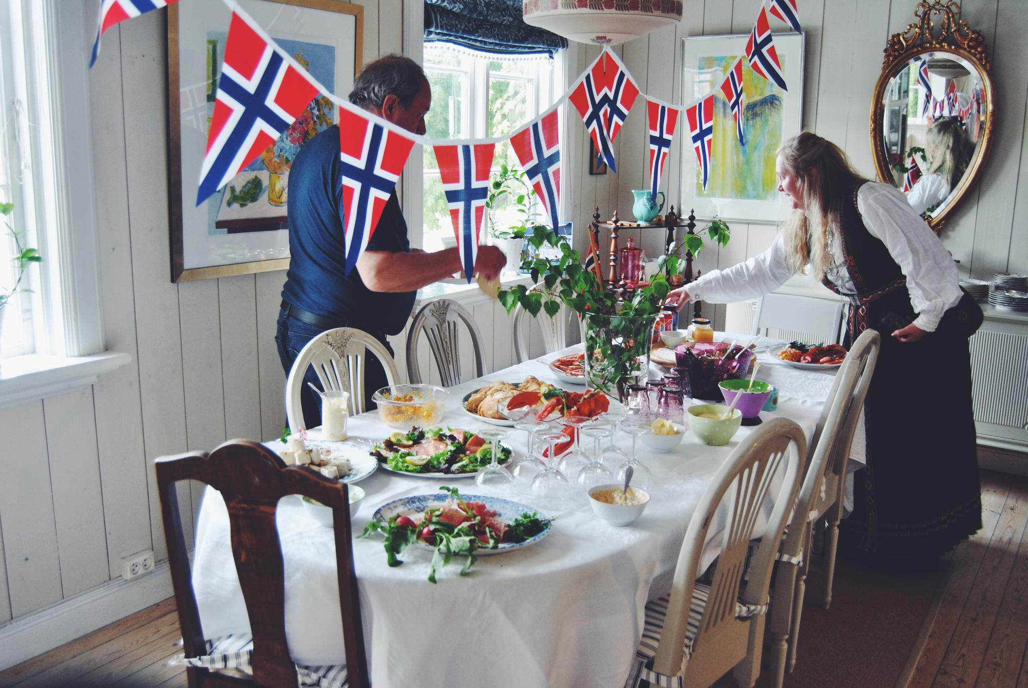 Two people getting ready for a 17 May breakfast on the Norwegian Constitution Day
