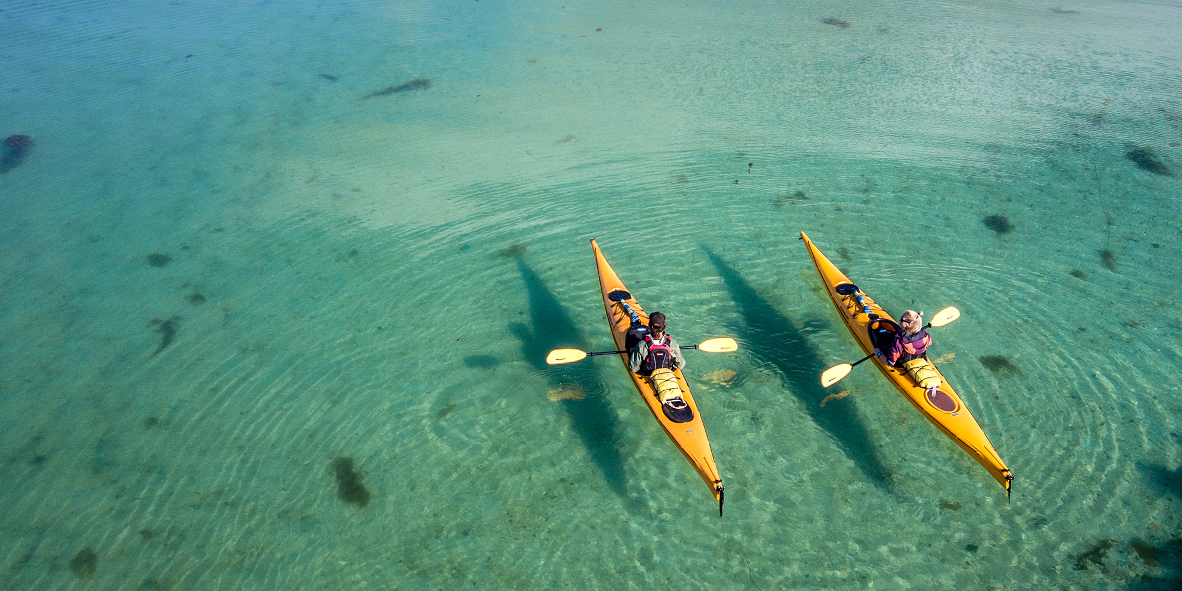 Two kayakers on the water close to Herøy in Helgeland, Northern Norway.