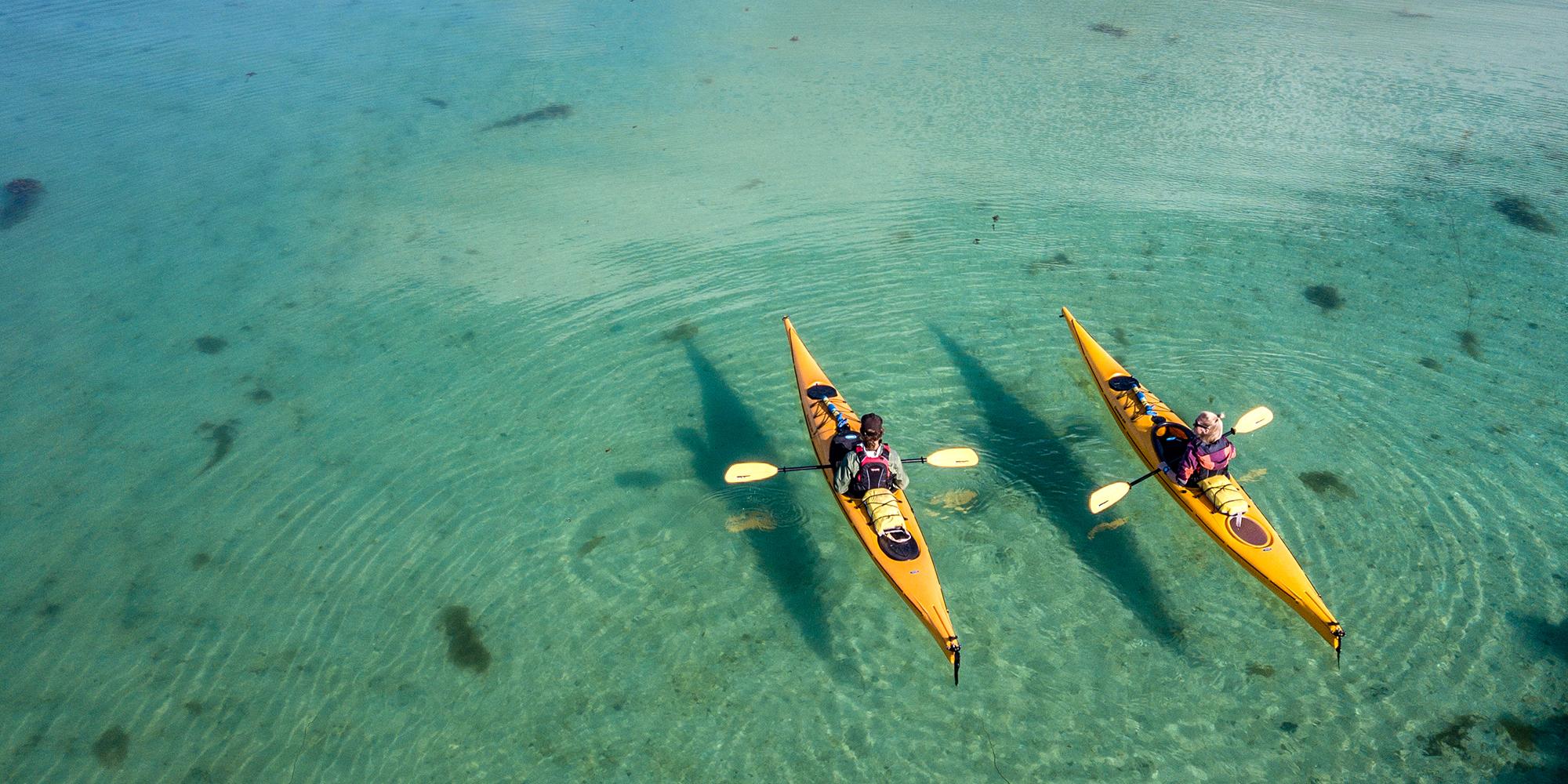 Two kayakers on the water close to Herøy in Helgeland, Northern Norway.