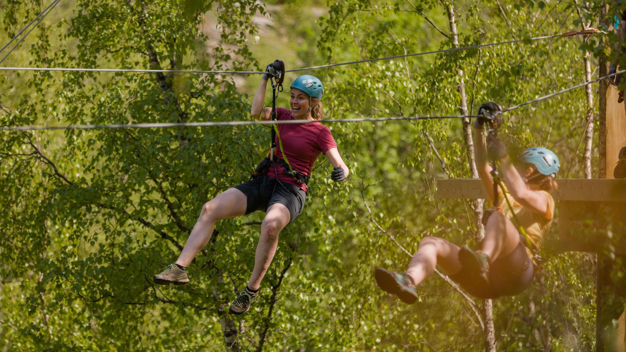Women ziplining in Geiranger
