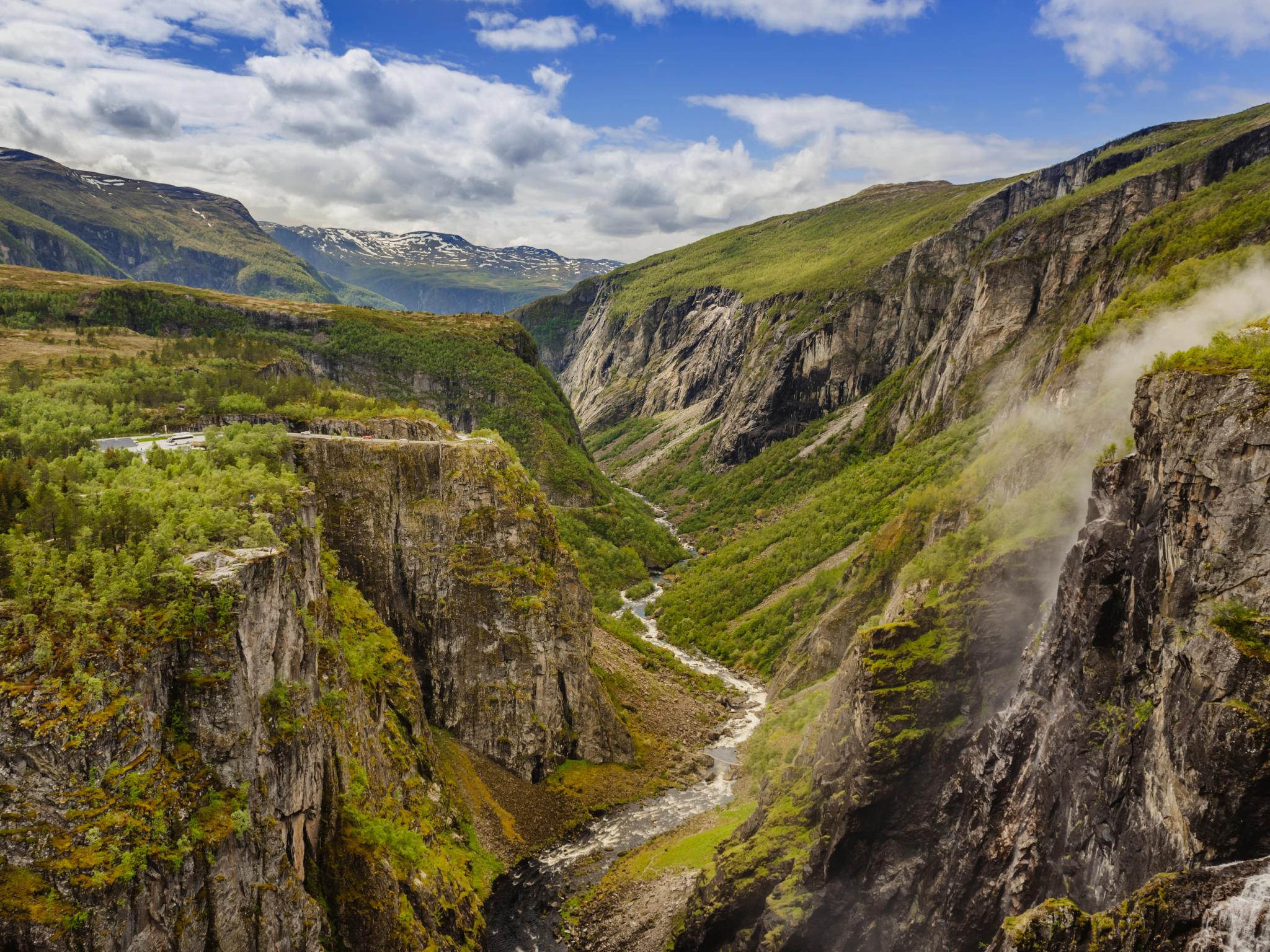 A lush valley with a river below