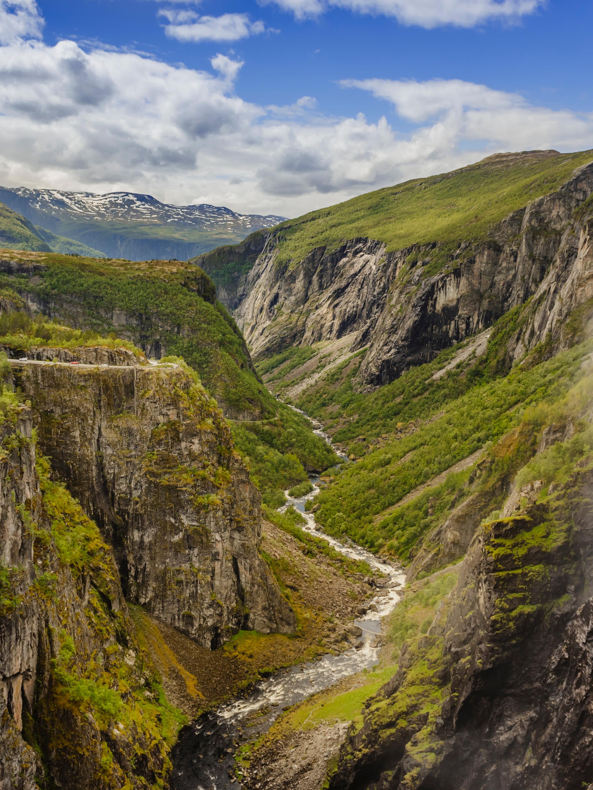 A lush valley with a river below