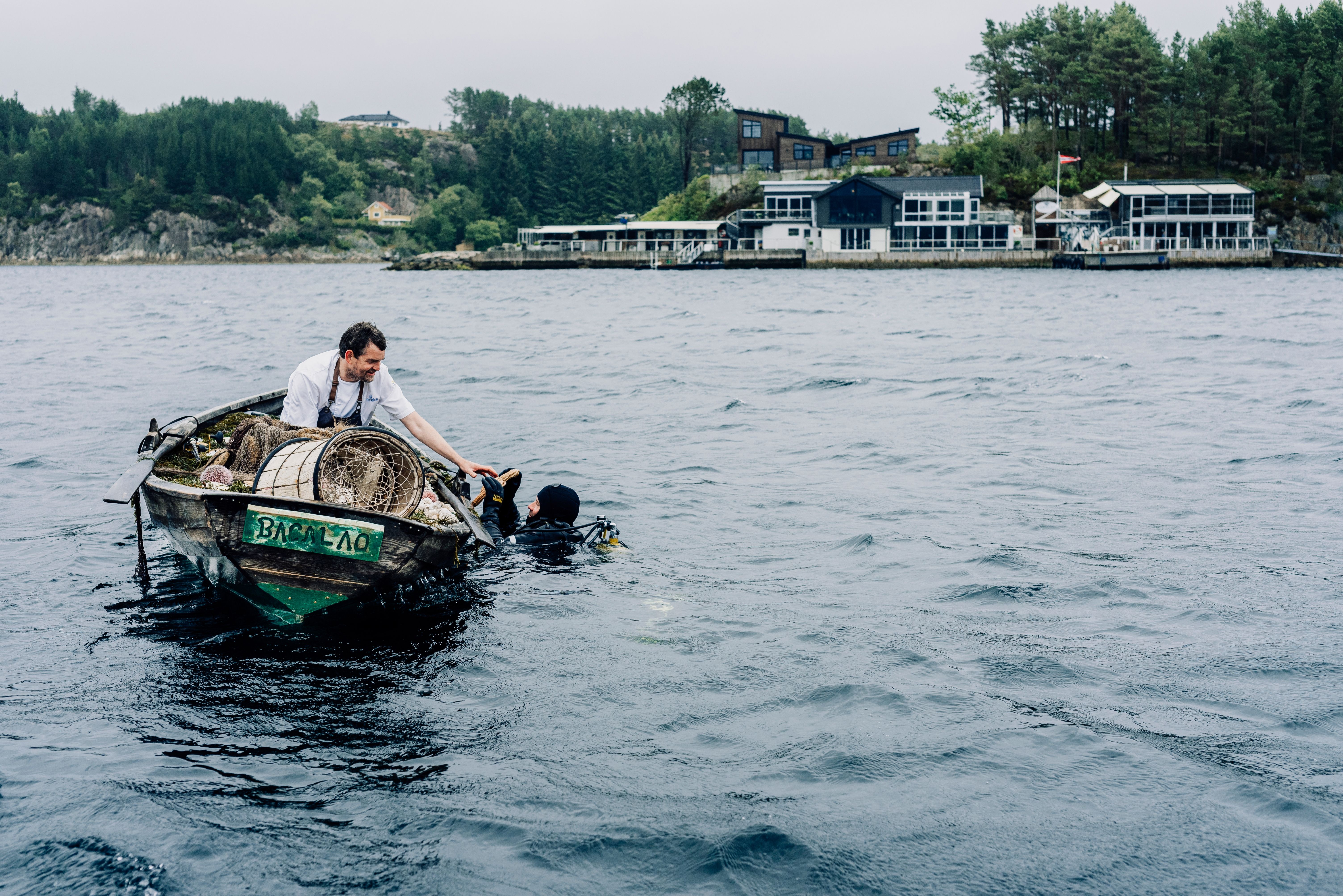 A chef in a boat collecting seafood for Cornelius Restaurant in Norway.