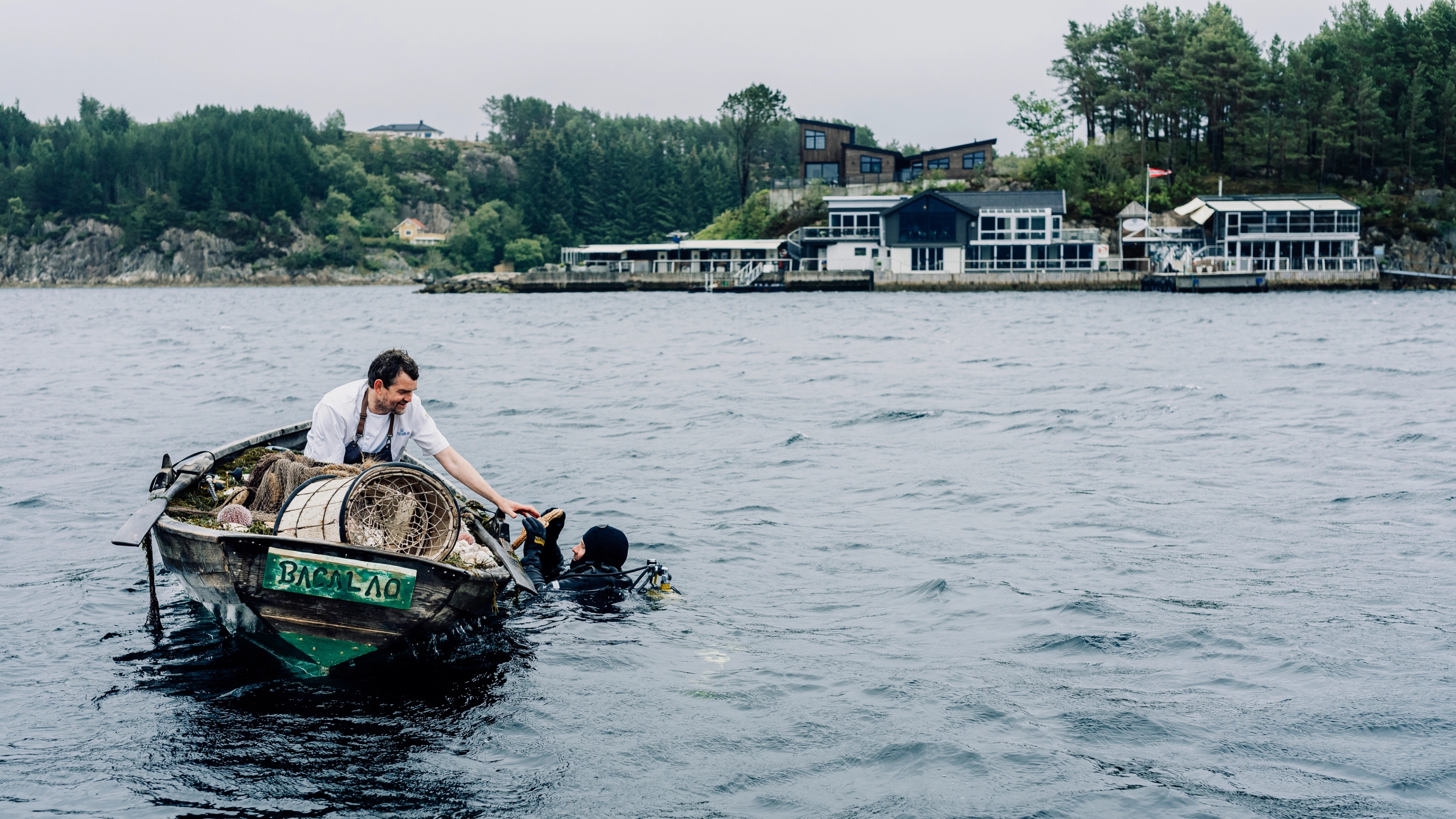 A chef in a boat collecting seafood for Cornelius Restaurant in Norway.