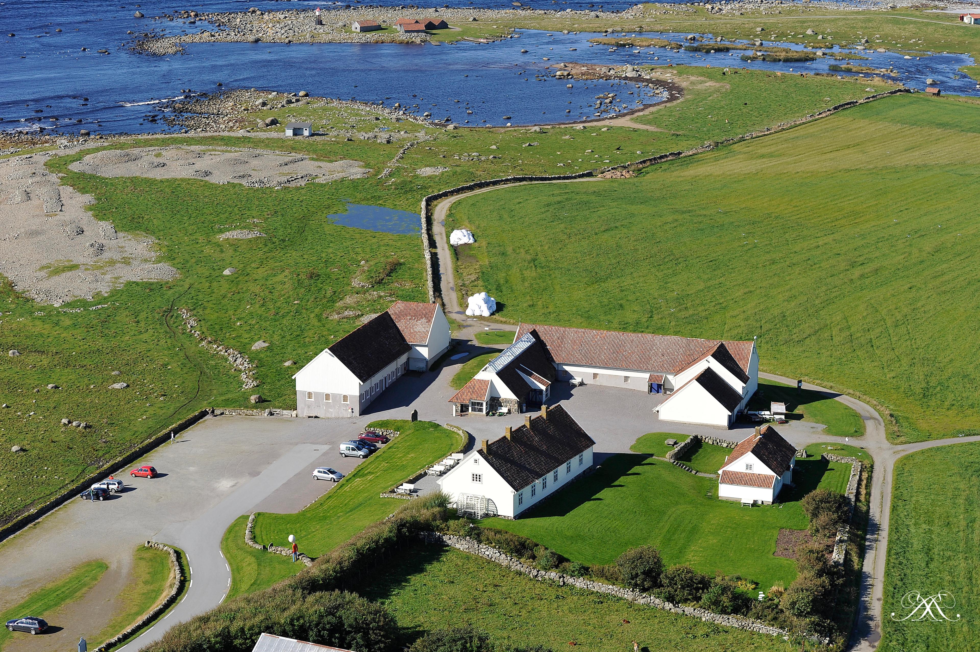 Hå Gamle Prestegard and Obrestad lighthouse by the coast.