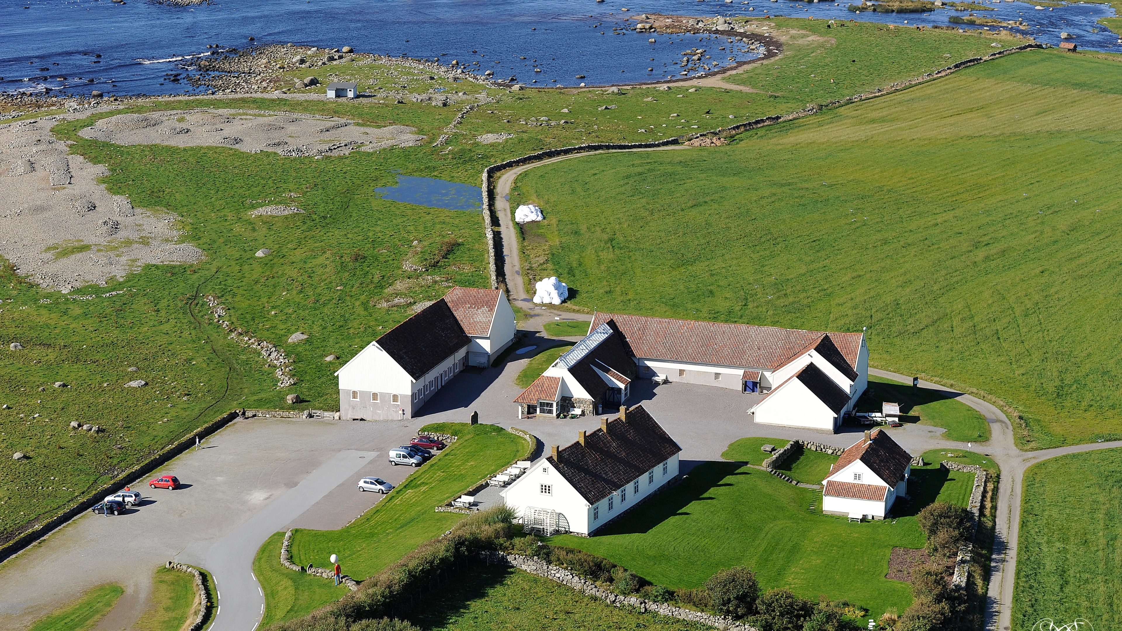 Hå Gamle Prestegard and Obrestad lighthouse by the coast.