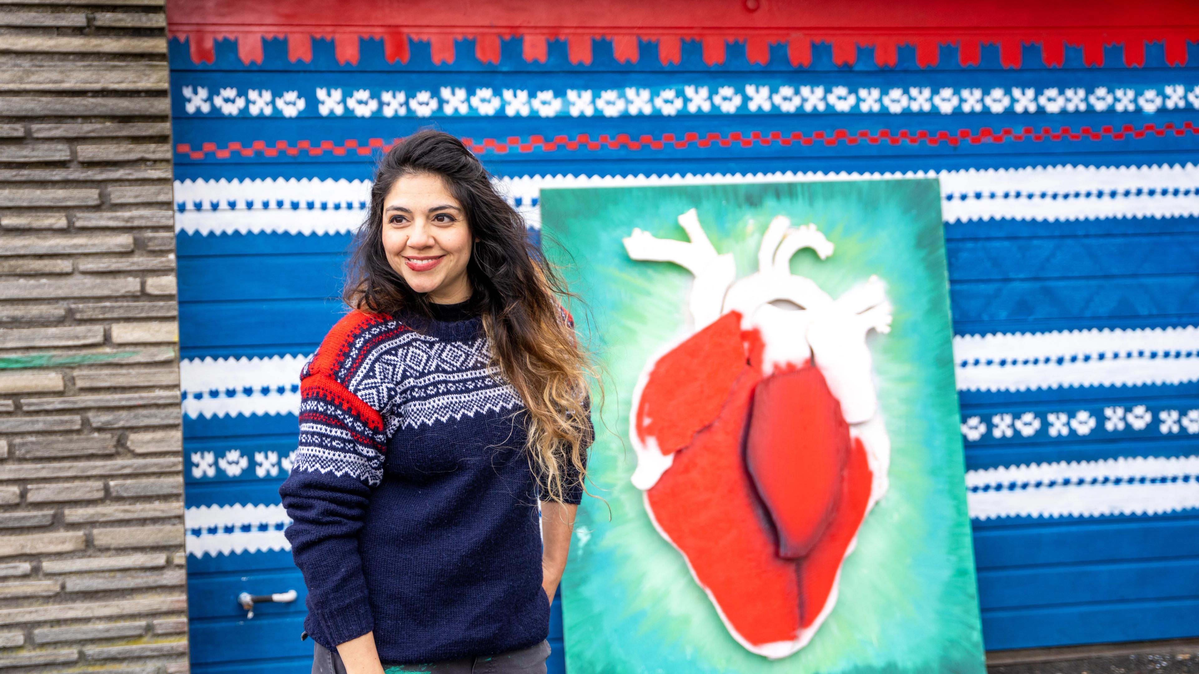 Street artist Algebra standing in front of a piece in progress, Stavanger, Fjord Norway.