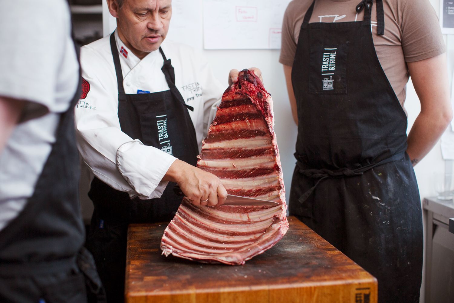 Chefs slicing meat at Restaurant Trasti and Trine in Alta, Northern Norway