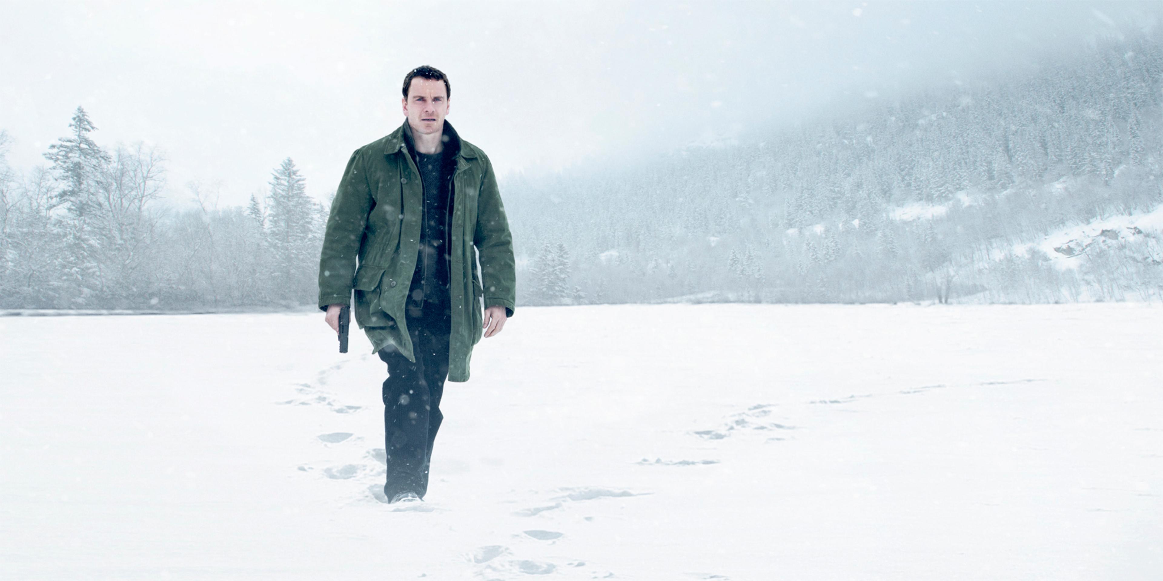 A man with a gun walking in the snow. From the movie poster for Jo Nesbø’s The Snowman.