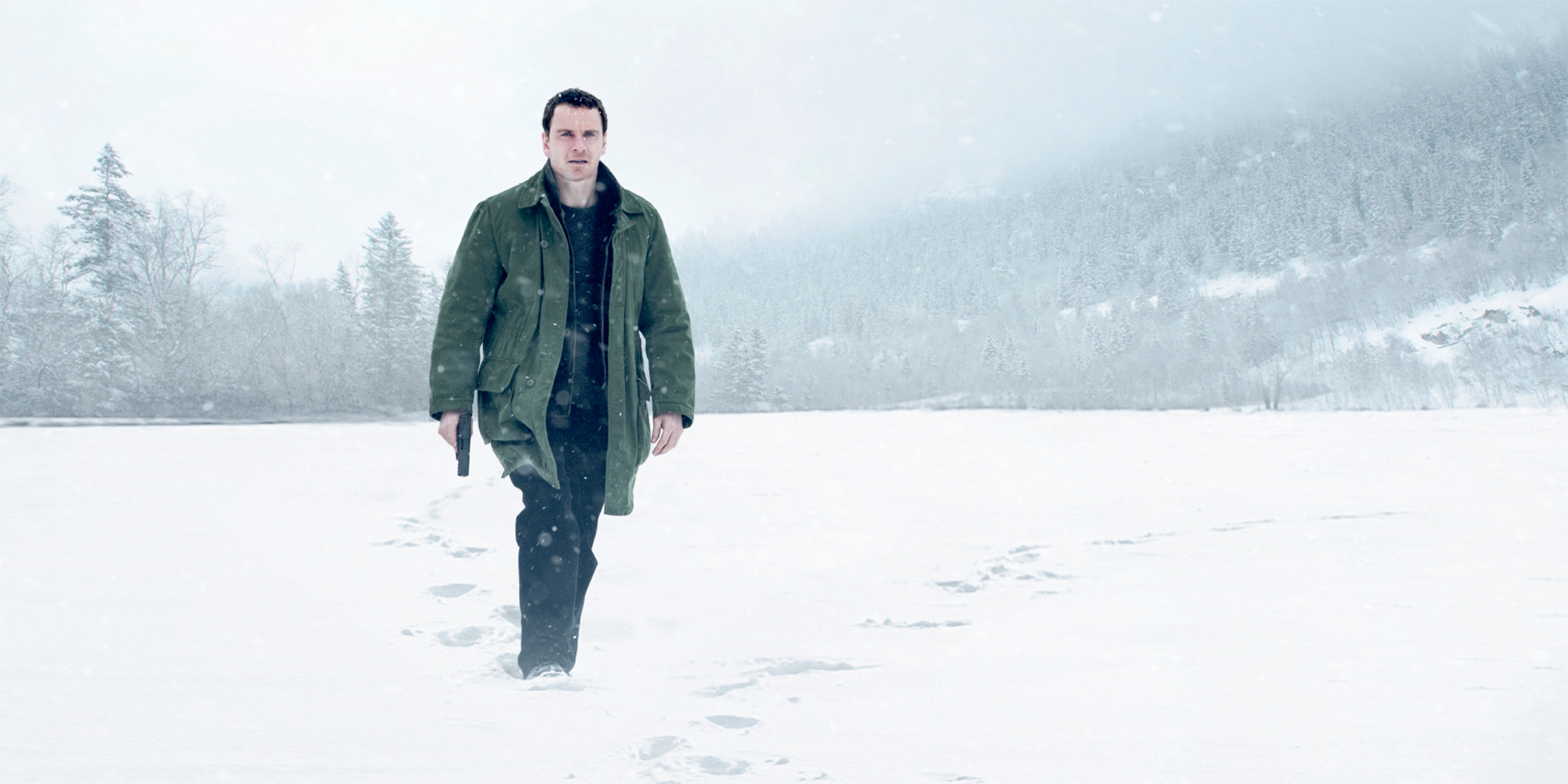 A man with a gun walking in the snow. From the movie poster for Jo Nesbø’s The Snowman.