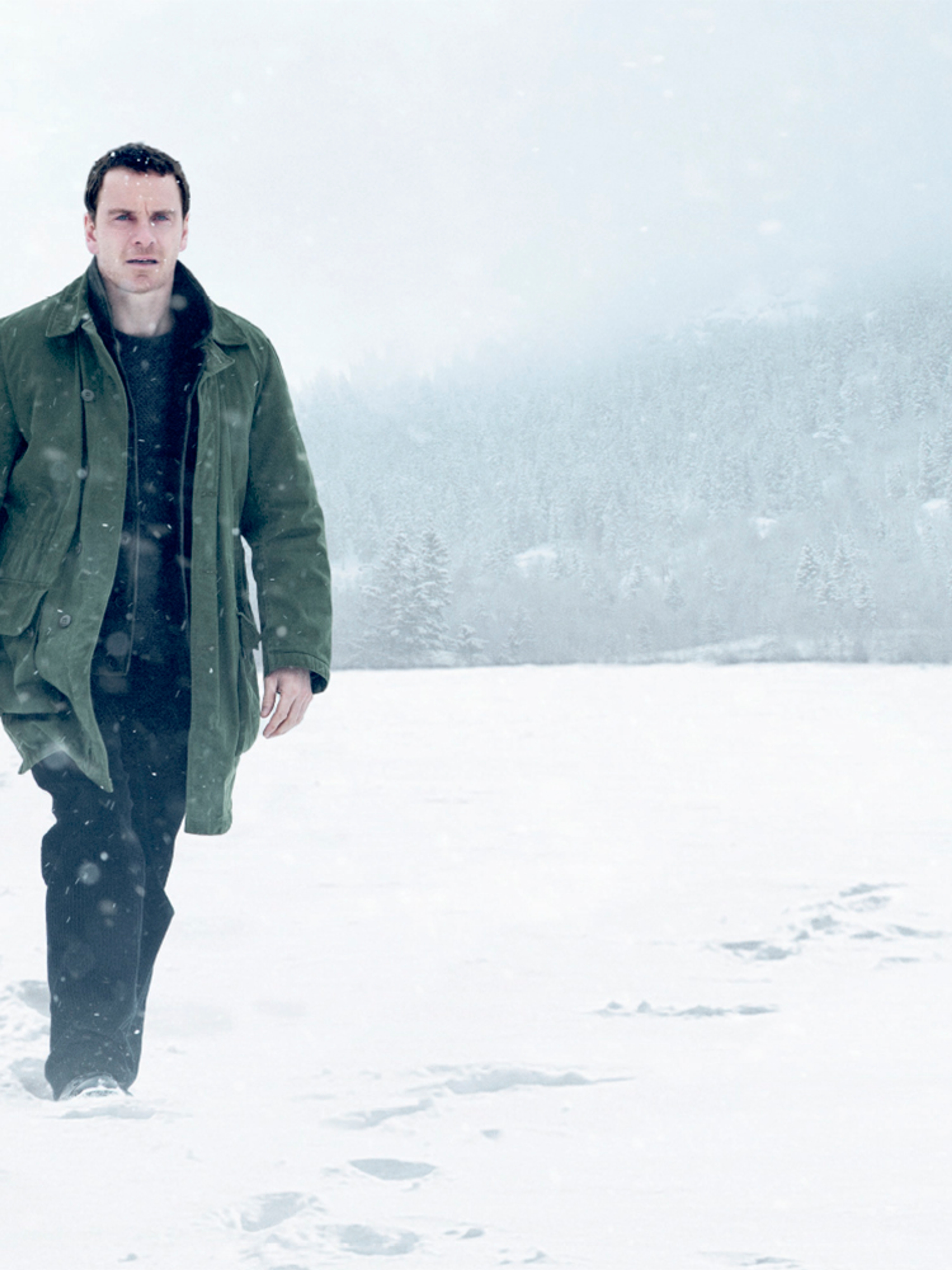 A man with a gun walking in the snow. From the movie poster for Jo Nesbø’s The Snowman.