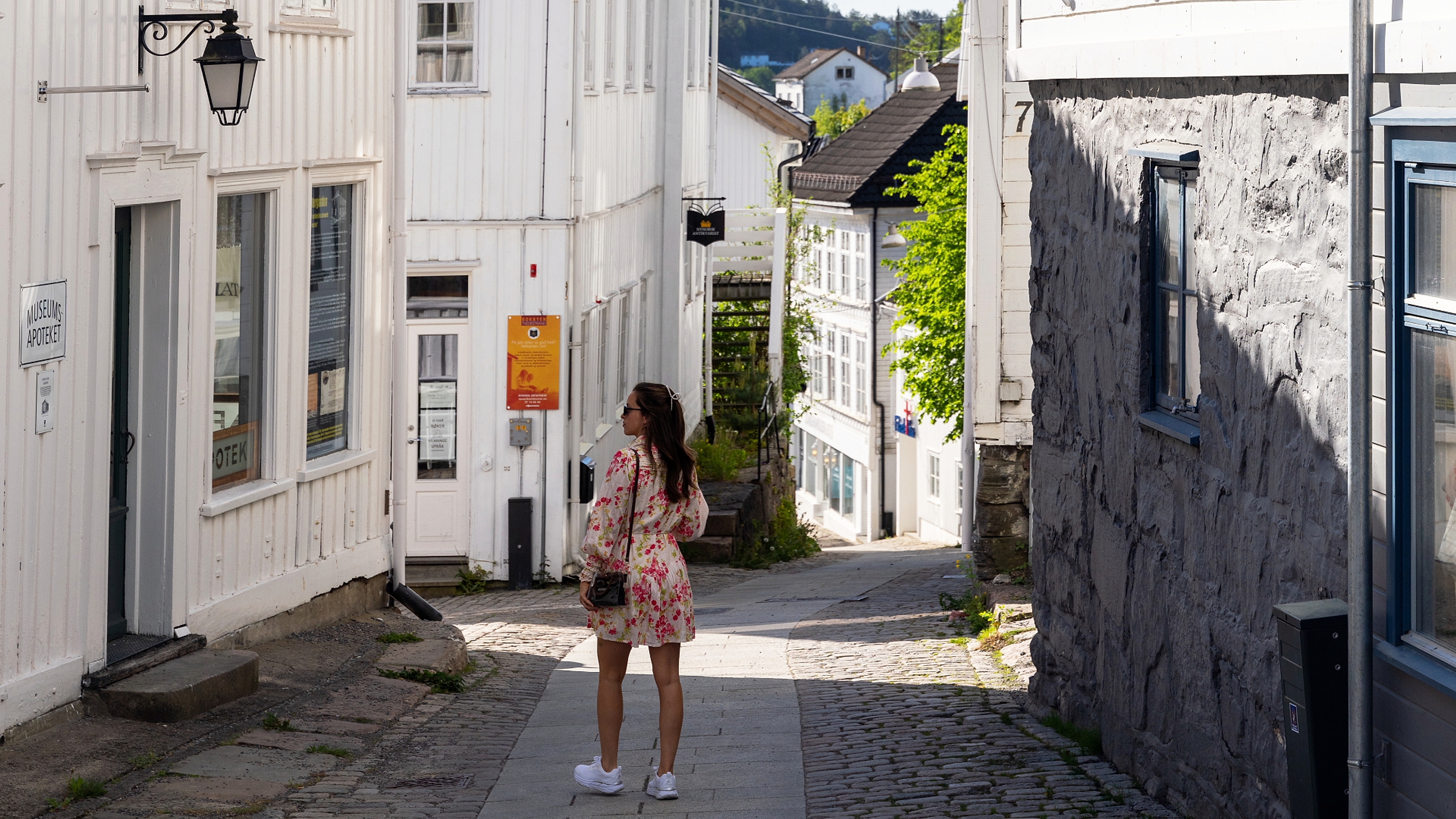 Woman walking in narrow streets in Tvedestrand, Southern Norway