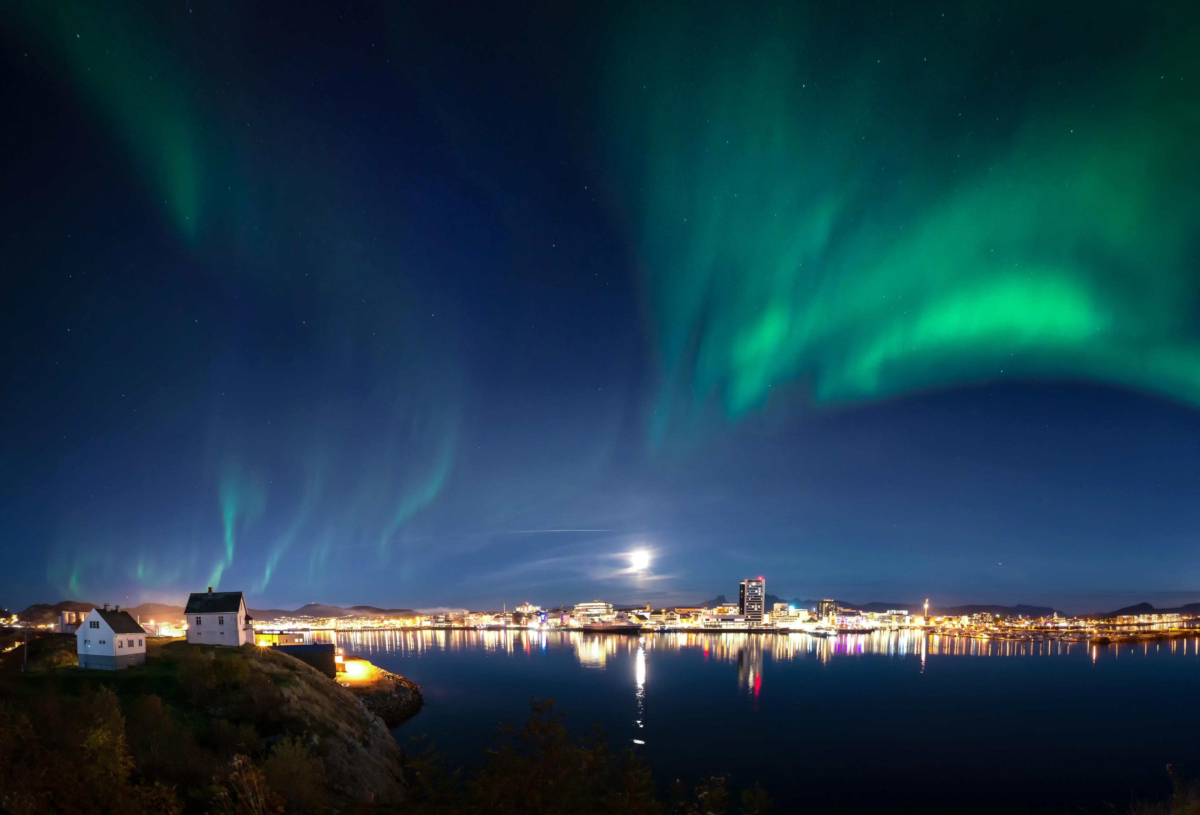 The northern lights dancing across the sky above the city of Bodø, Northern Norway