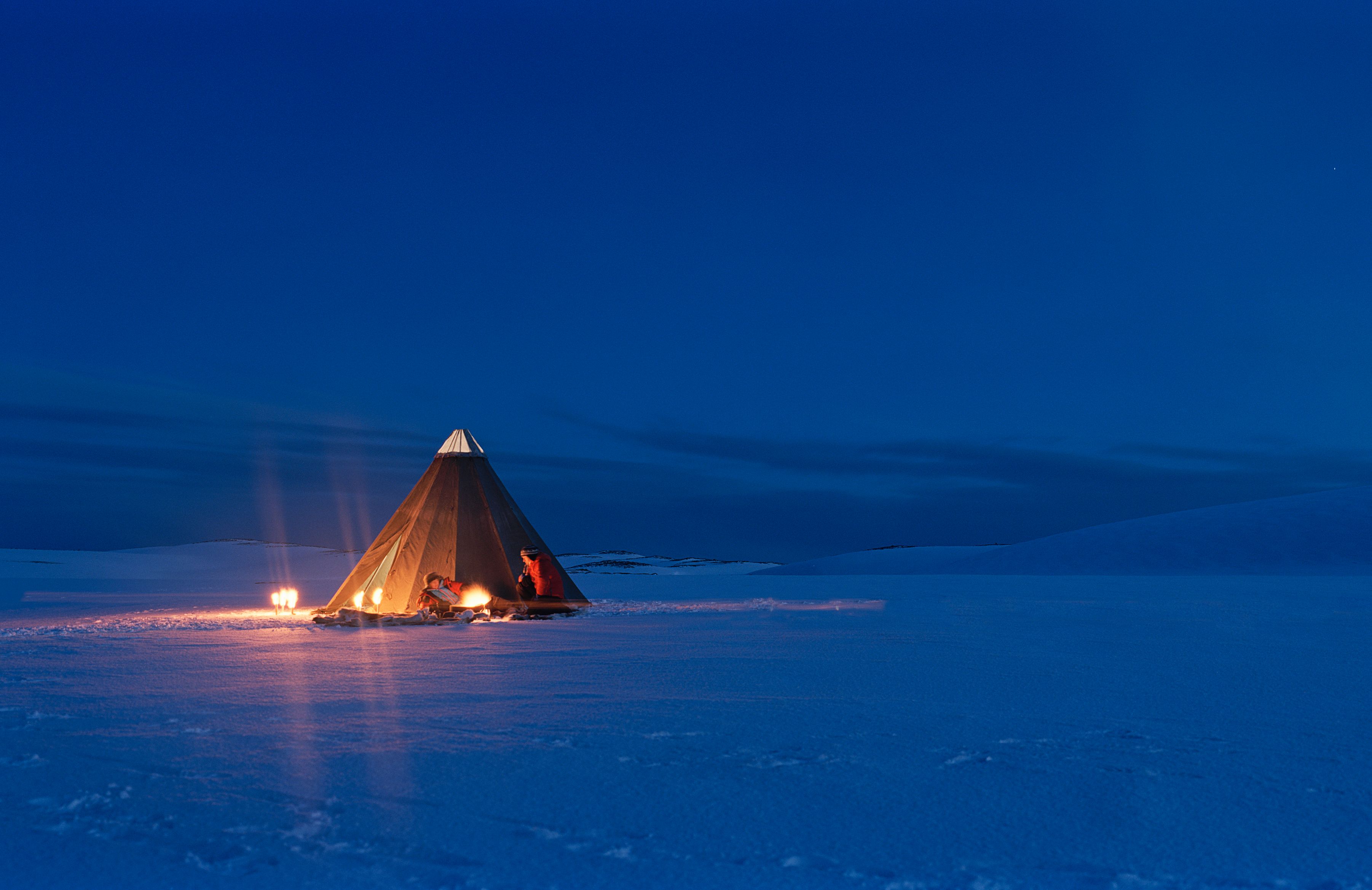 A tent on a snowy mountain plateau