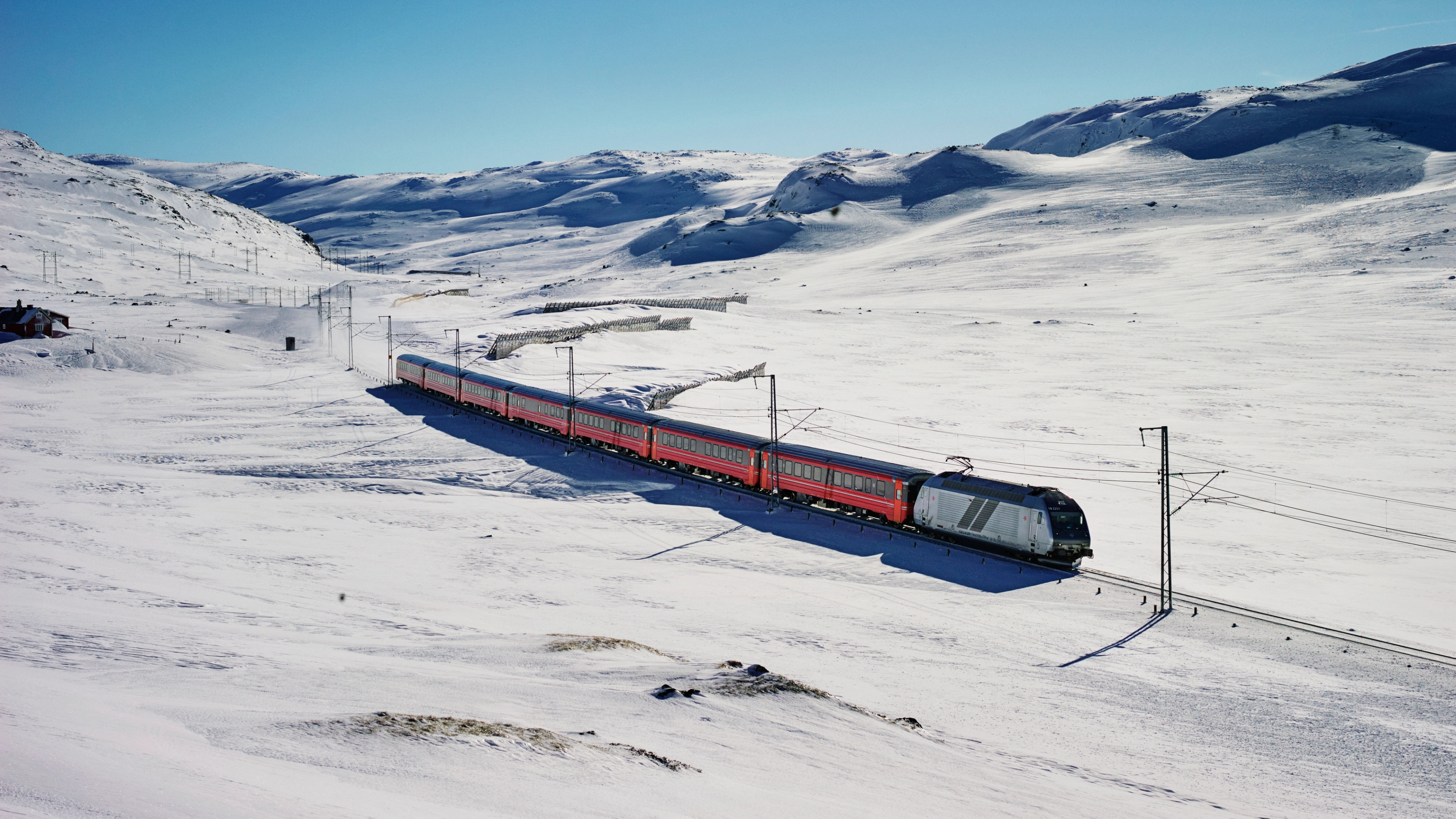 A train going through snowy mountains in Geilo, Eastern Norway