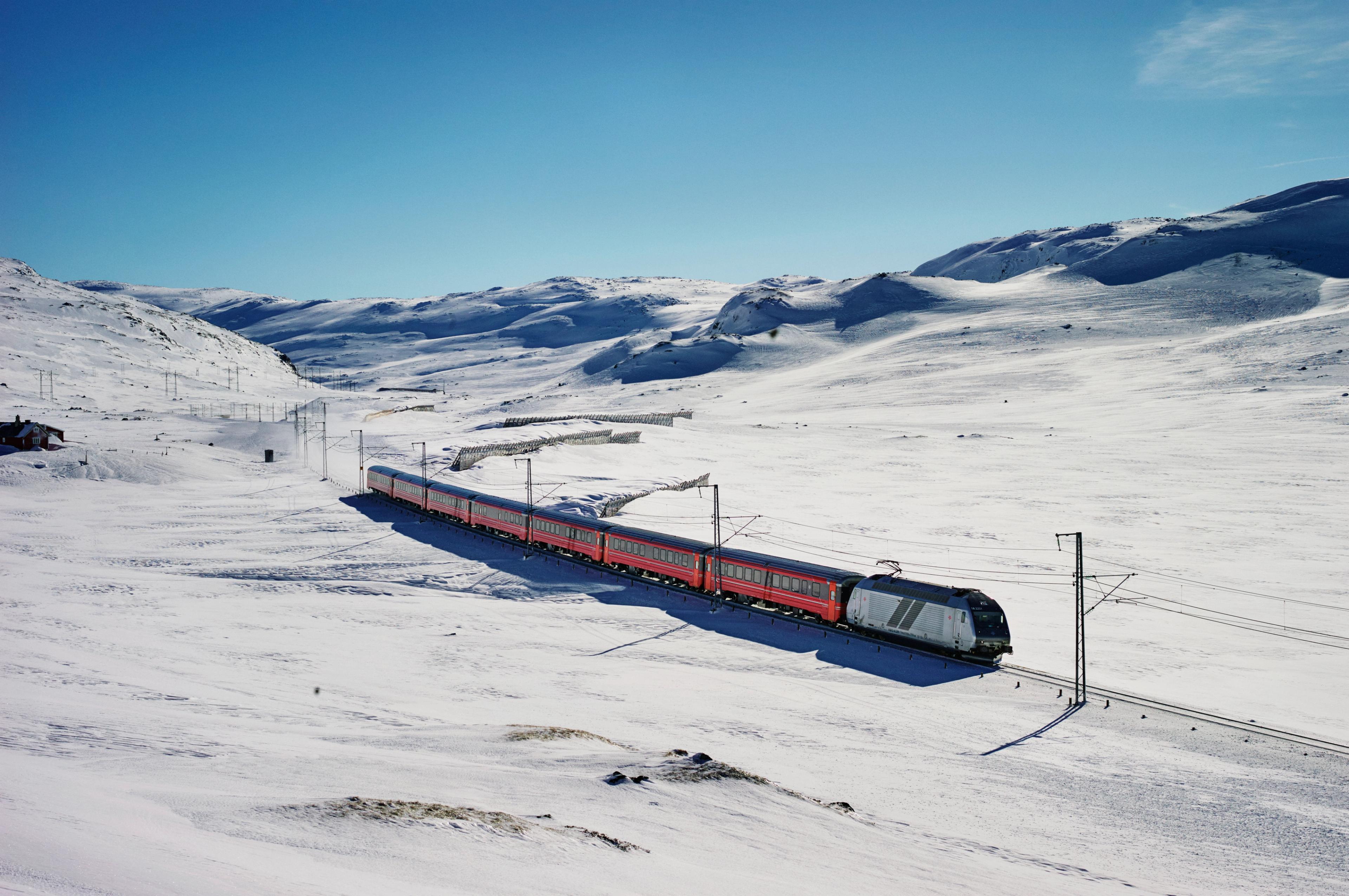 A train going through snowy mountains in Geilo, Eastern Norway
