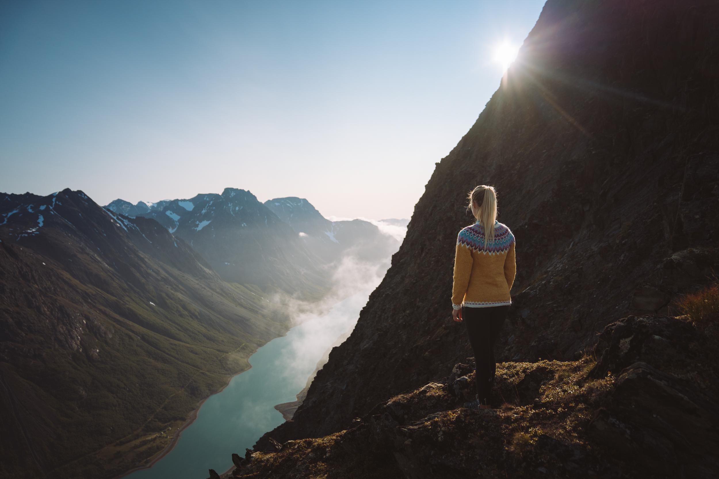 A woman is admiring the fjord view on a hike in Tromsø, Northern Norway