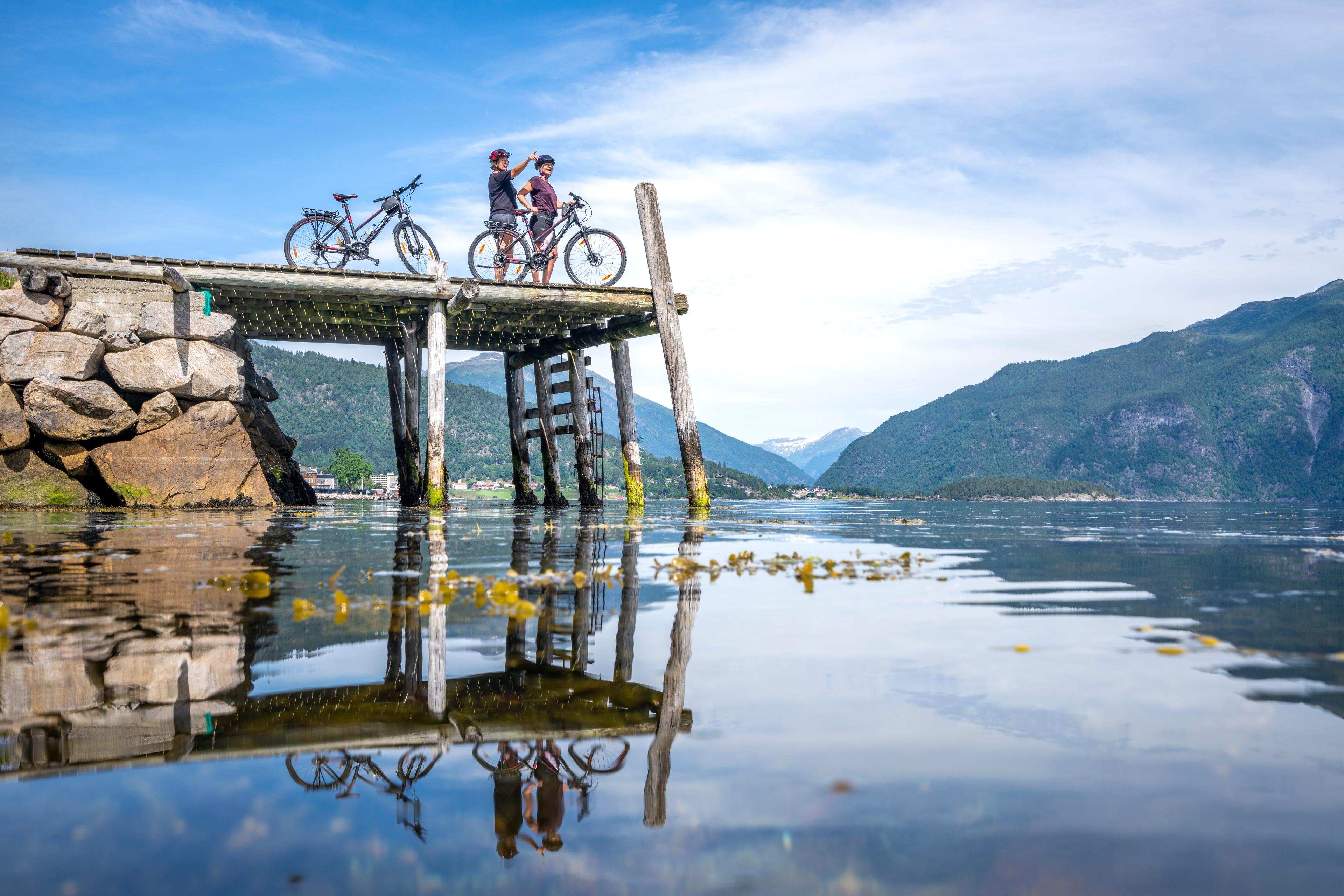 Cyclists on a pier by the fjord in Norway.
