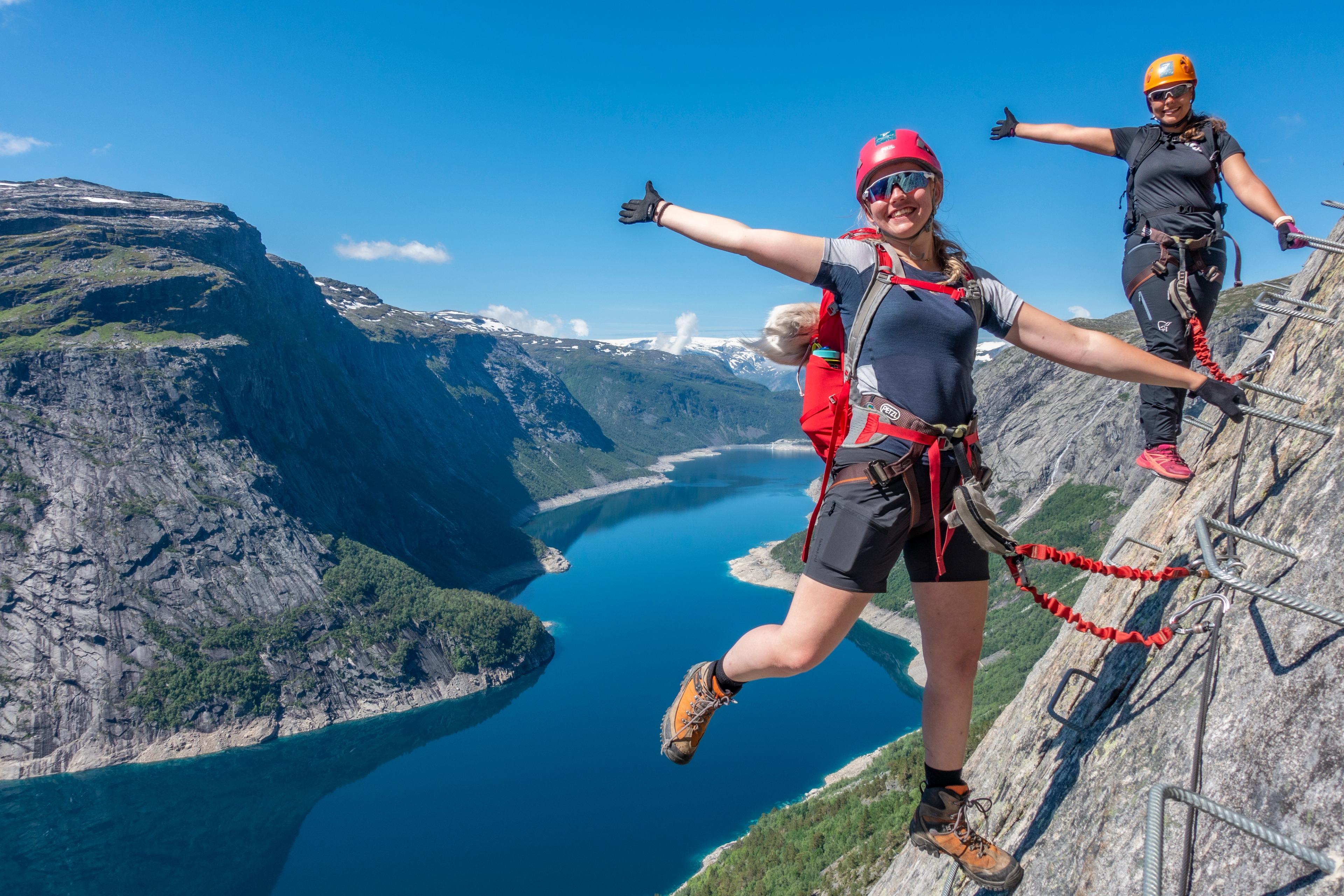 Two women climbing via ferrata Trolltunga