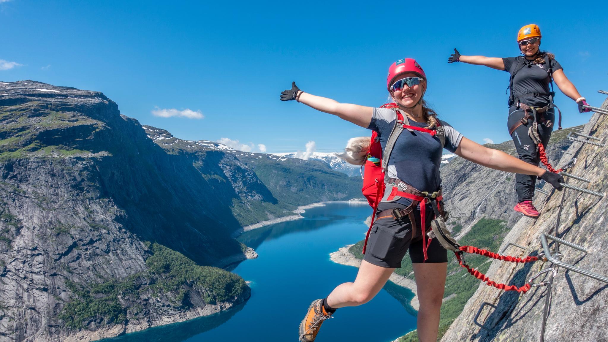 Two women climbing via ferrata Trolltunga
