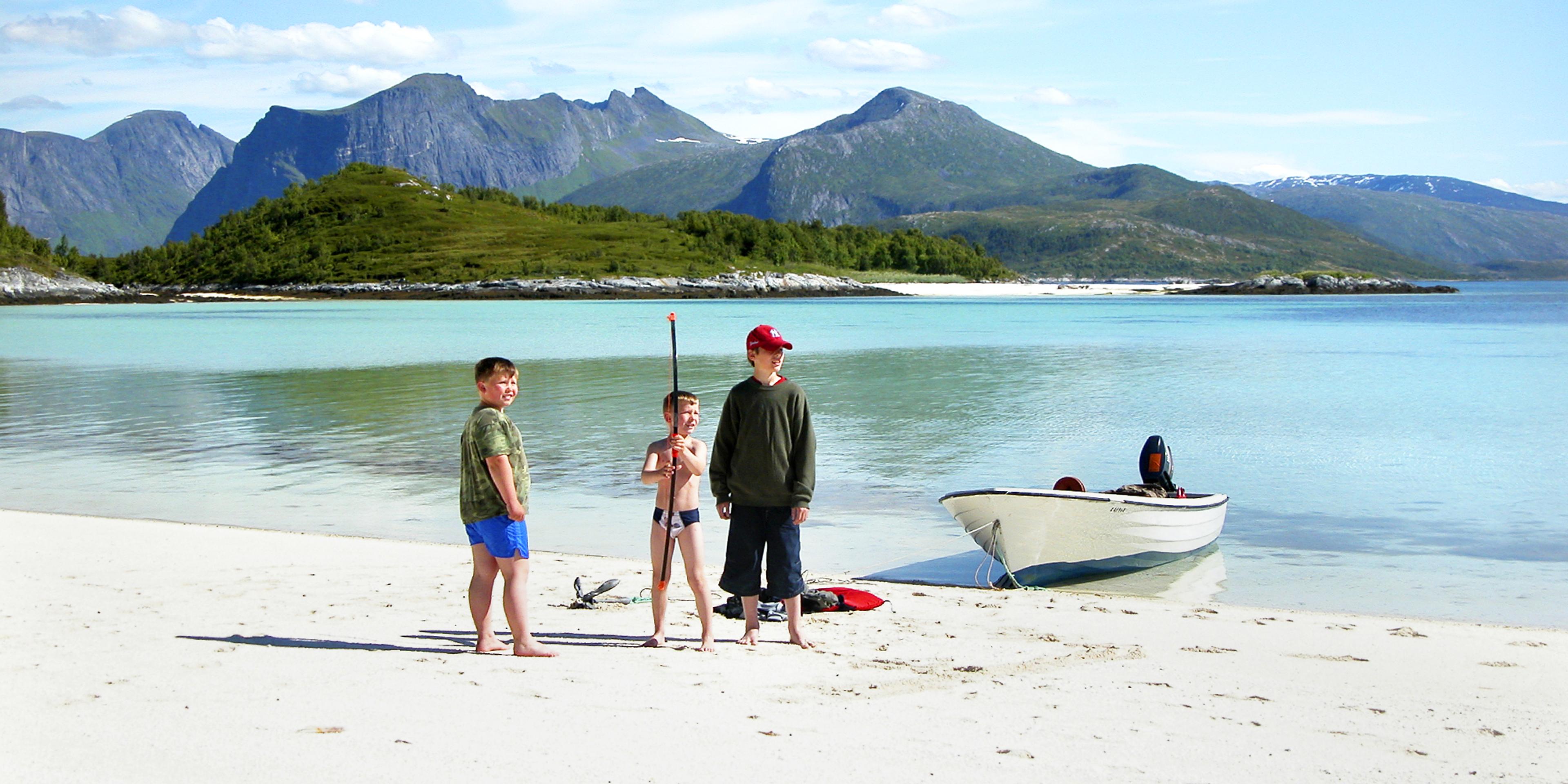 Three kids on a beach at Senja, Northern Norway