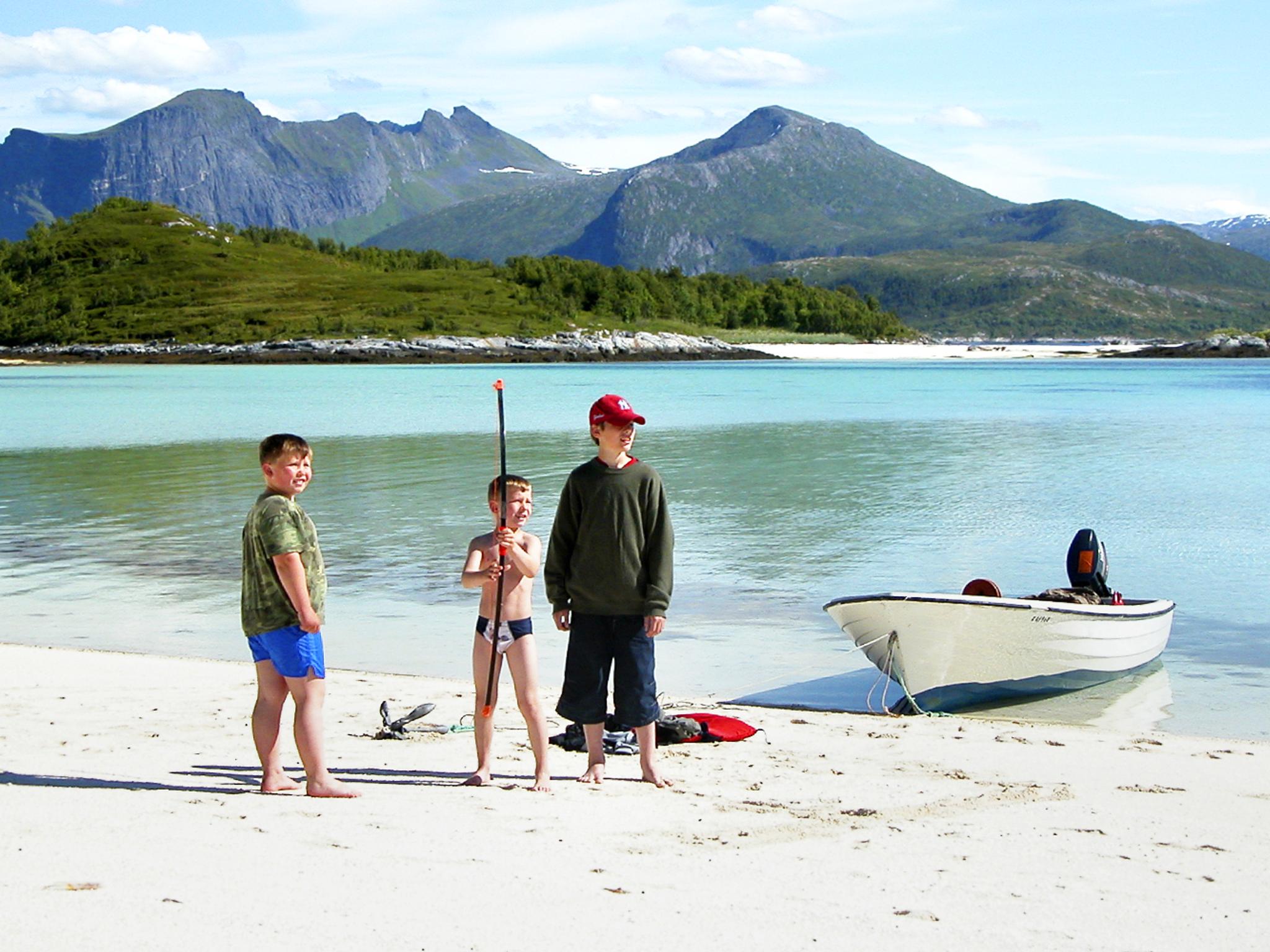 Three kids on a beach at Senja, Northern Norway