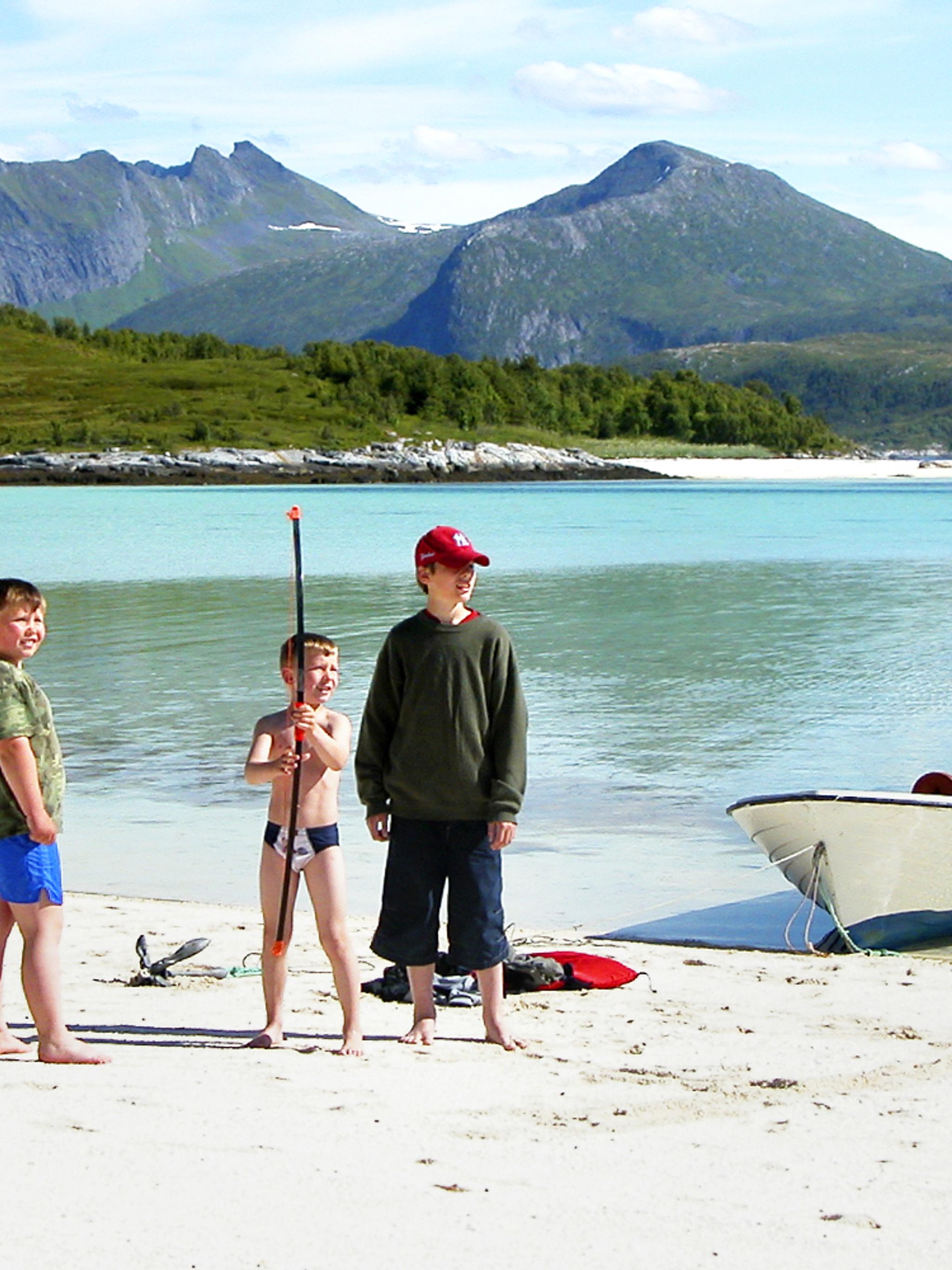 Three kids on a beach at Senja, Northern Norway