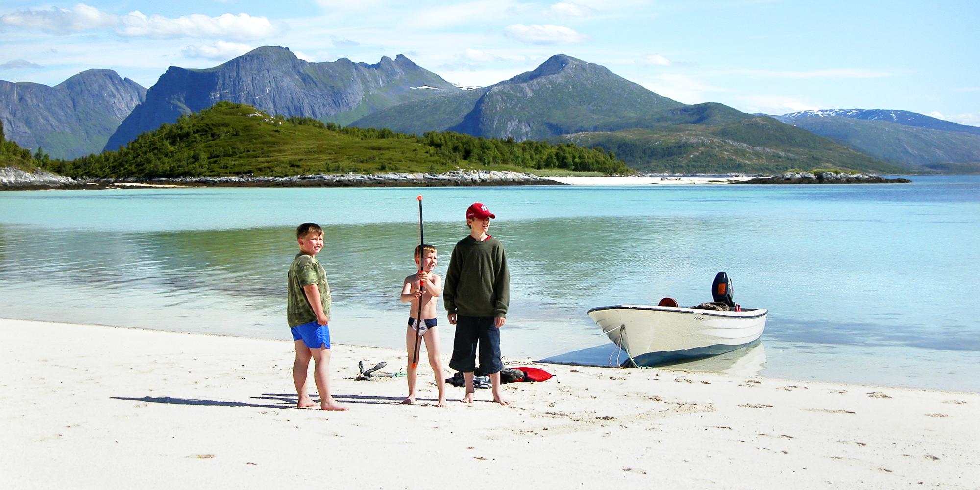 Three kids on a beach at Senja, Northern Norway