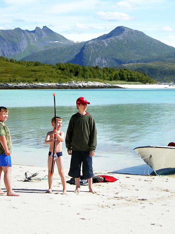 Three kids on a beach at Senja, Northern Norway