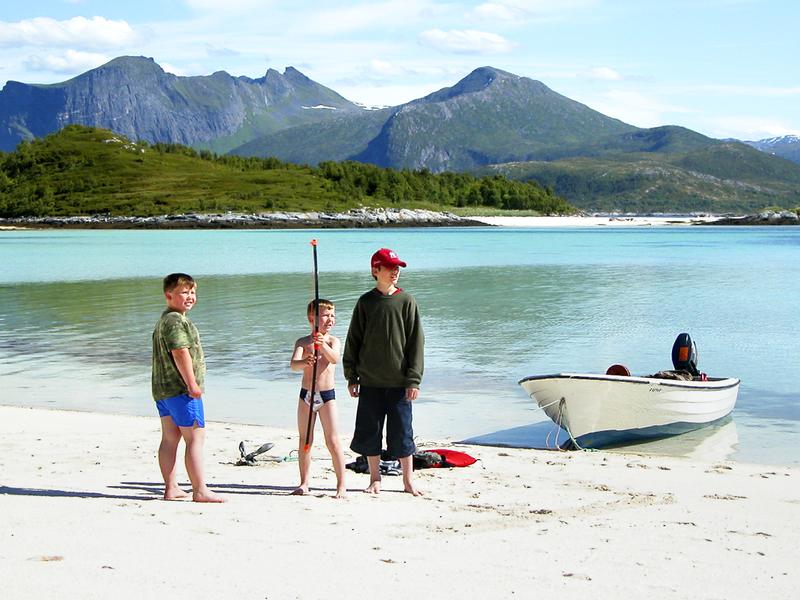 Three kids on a beach at Senja, Northern Norway
