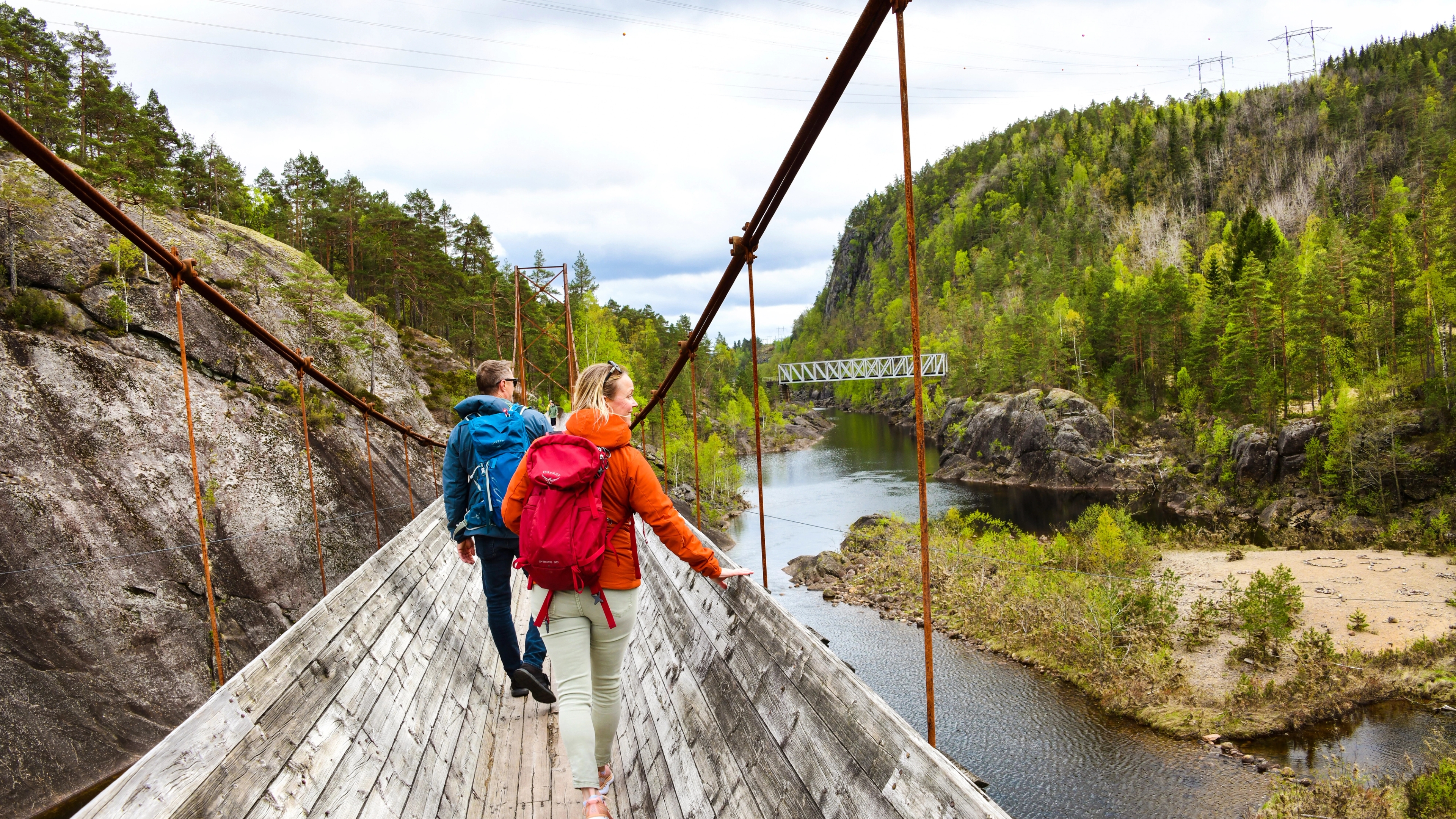 Two people hiking the Tømmerrenna timberslide in Vennesla, Southern Norway
